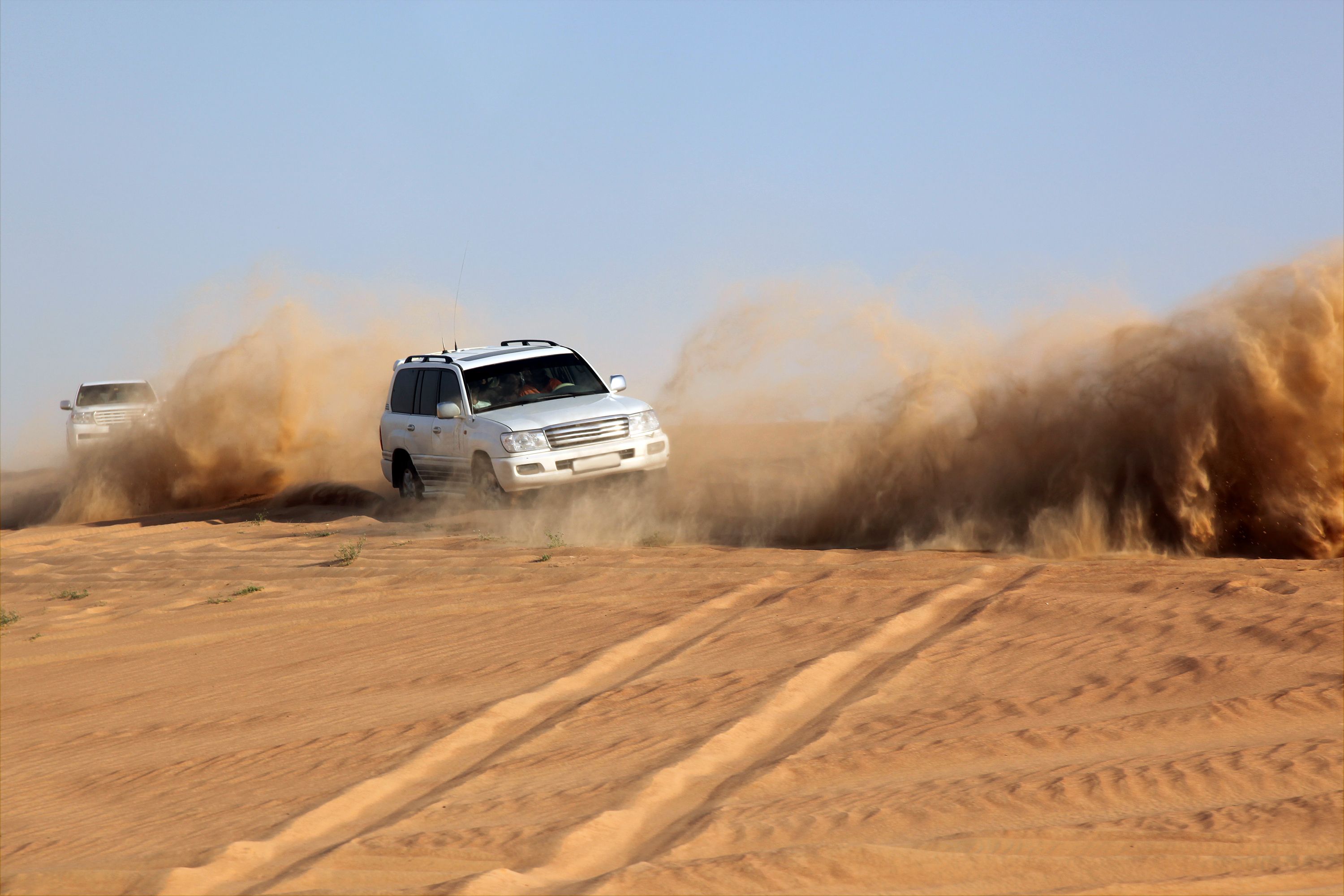 Sports Utility Vehicle speeding in desert sand, Dubai, UAE