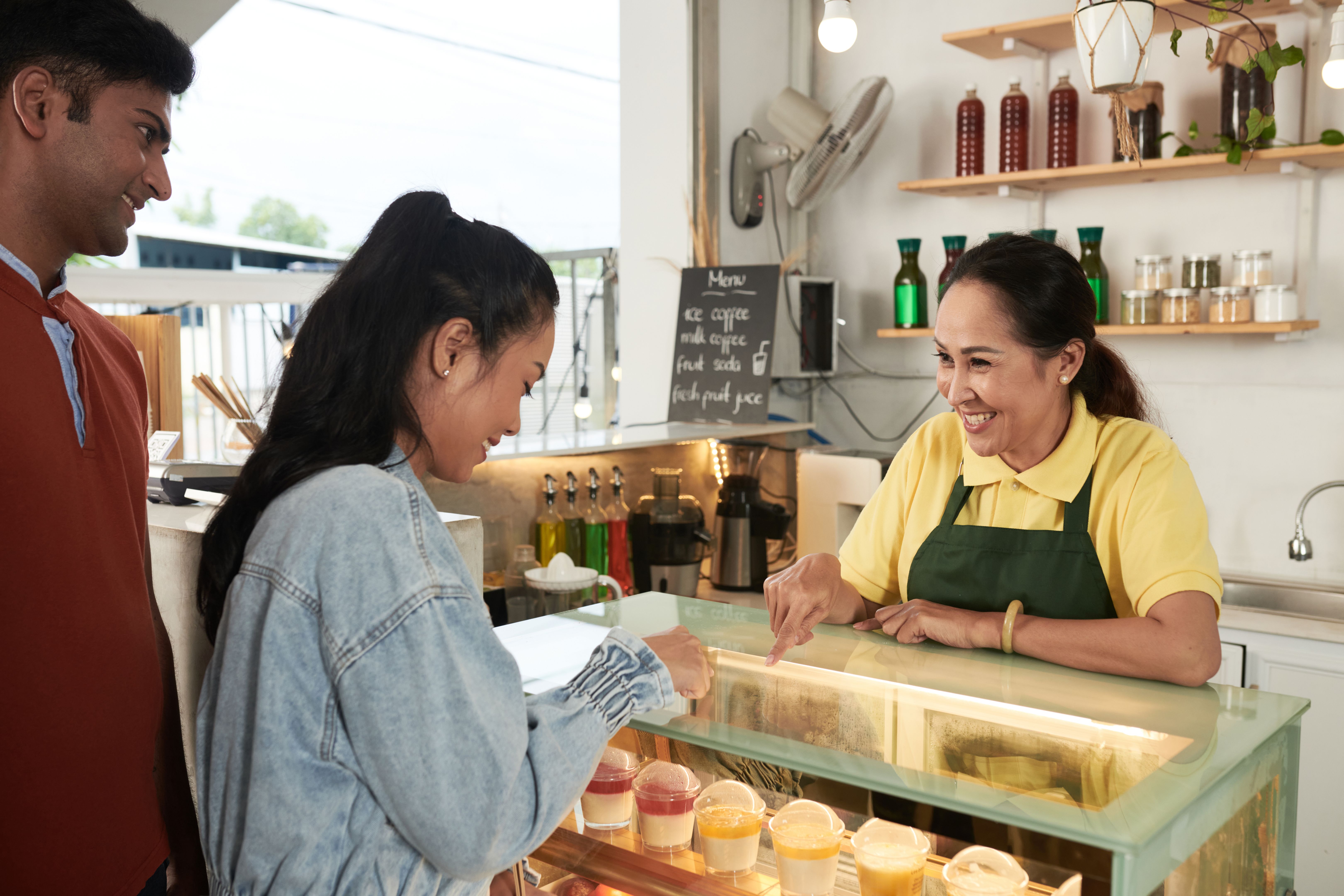 Barista Helping to Choose Dessert Barista Helping to Choose Dessert
