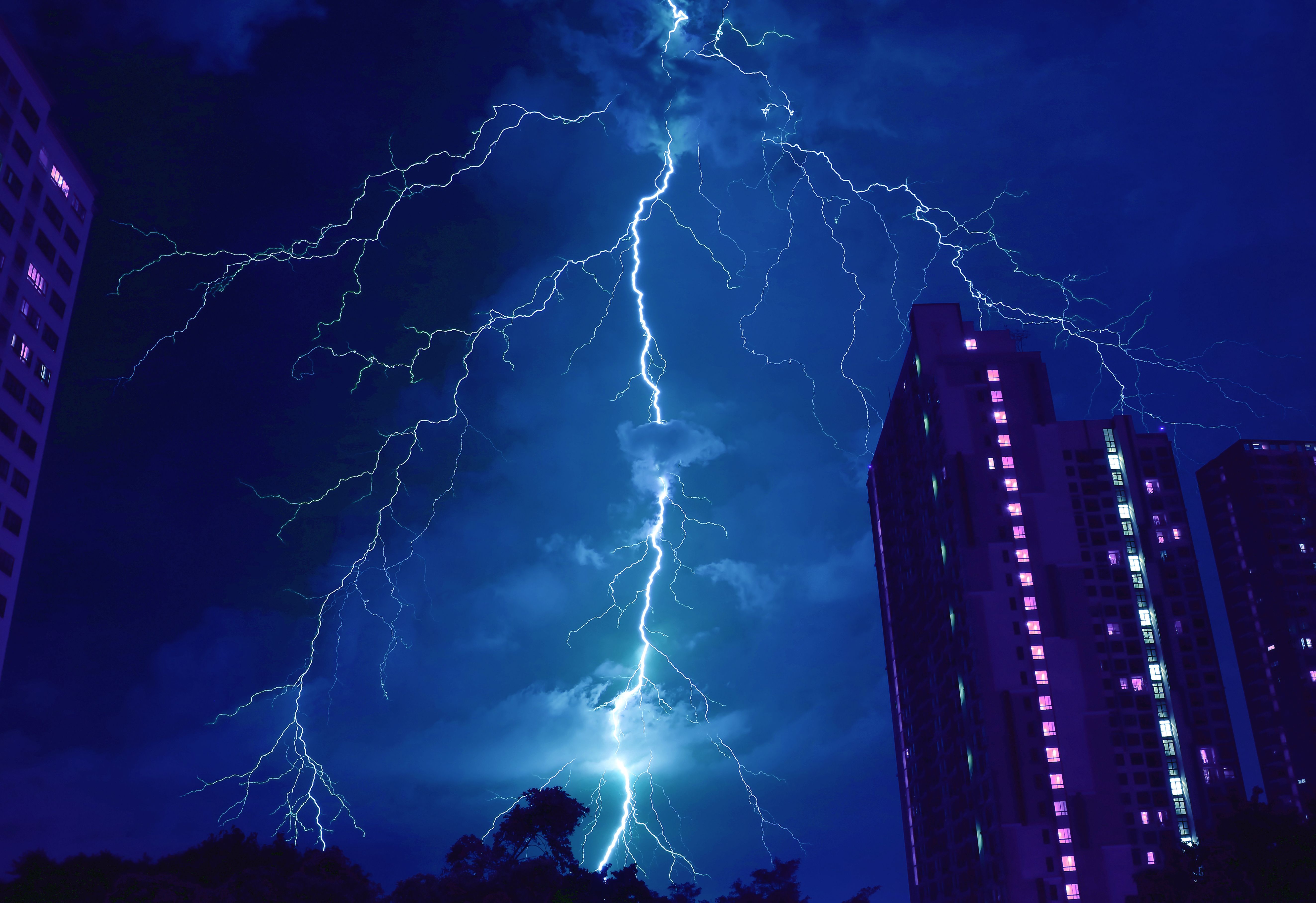 Pop Art Surreal Style of Incredible Lightning Strikes in Cobalt Blue Urban Night Sky