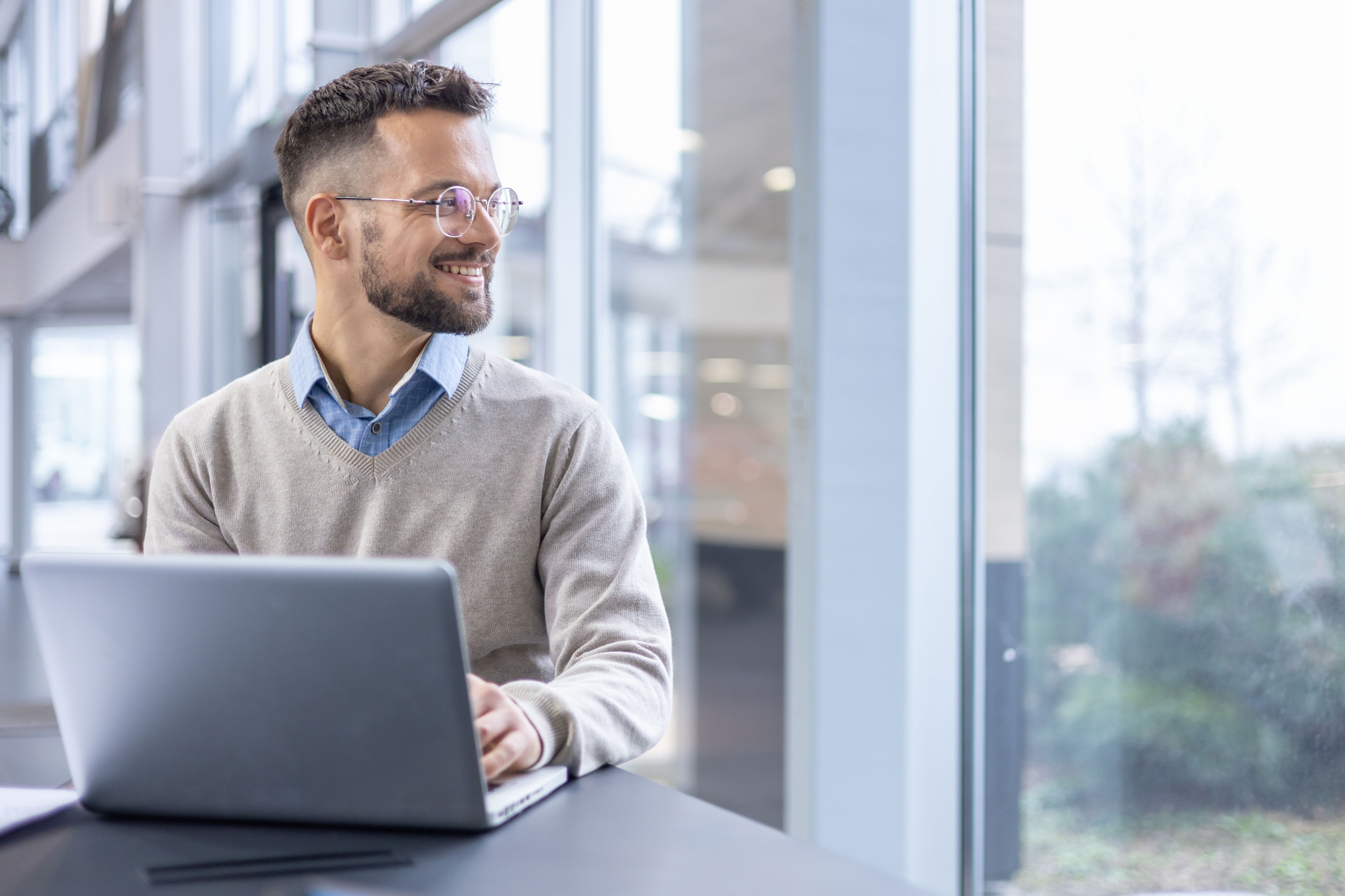 Man Working at Laptop Computer in Office
