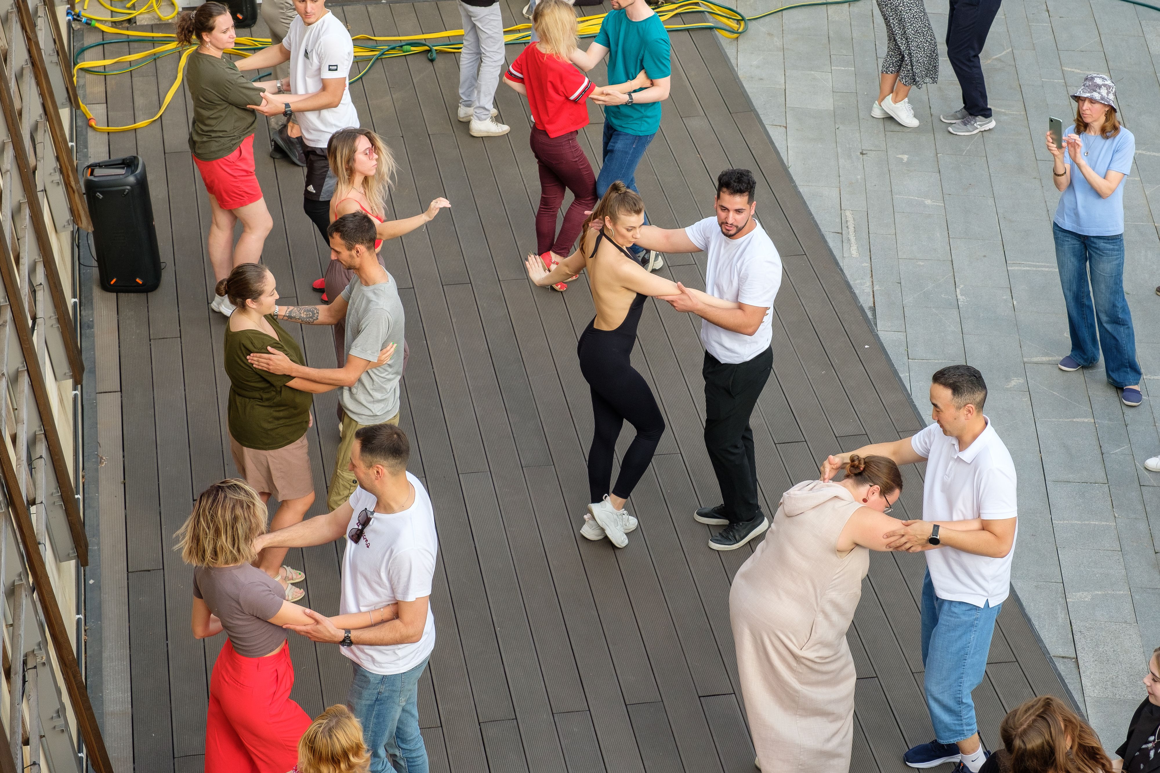Couples of people dancing Latin American dances on a street dance floor. Couples of people dancing Latin American dances on a street dance floor.