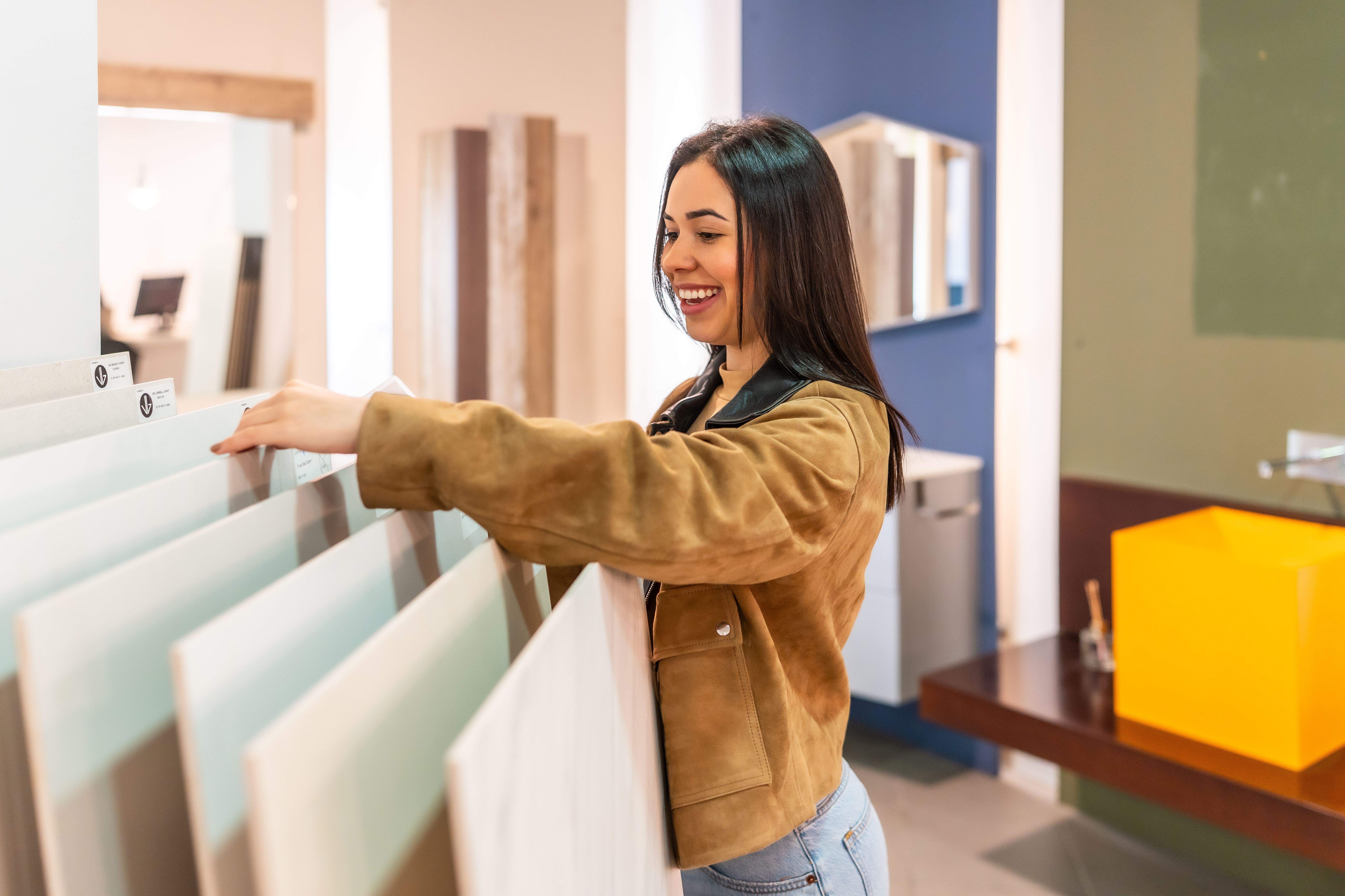 Young woman choosing tiles in a home improvement store