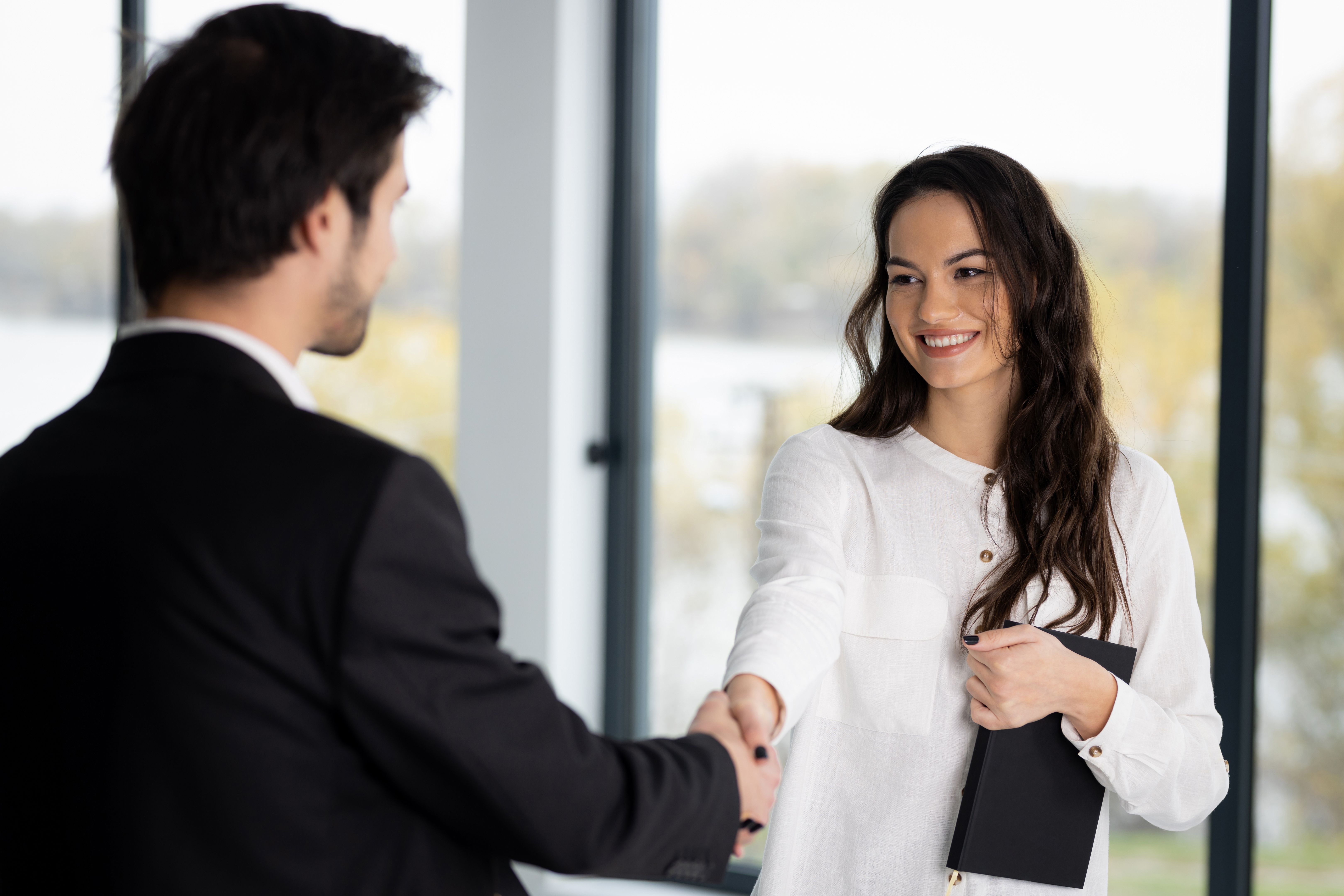 Two business people greeting each other