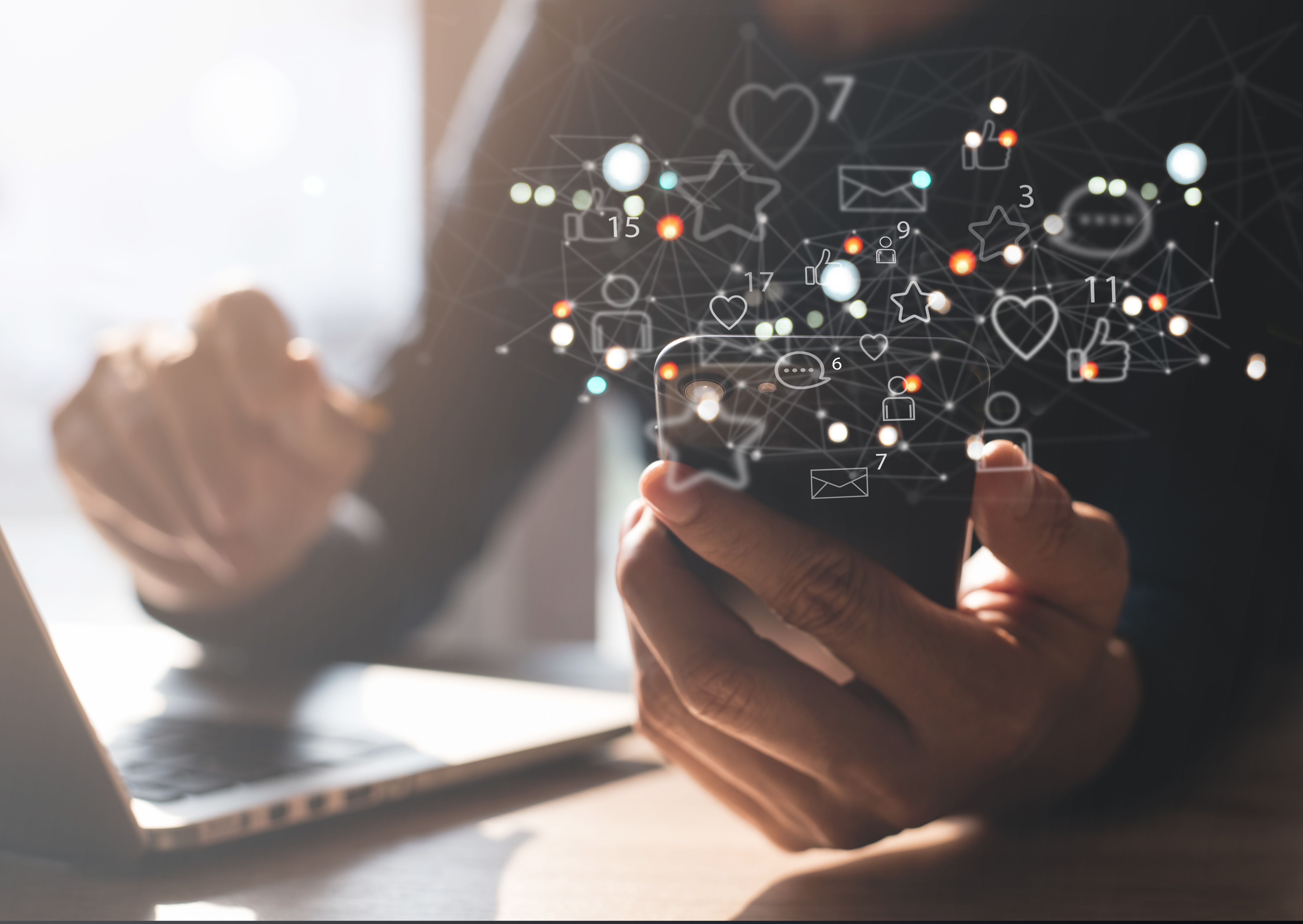 Man using mobile phone at home with social media apps icons on virtual screen, social media, digital marketing