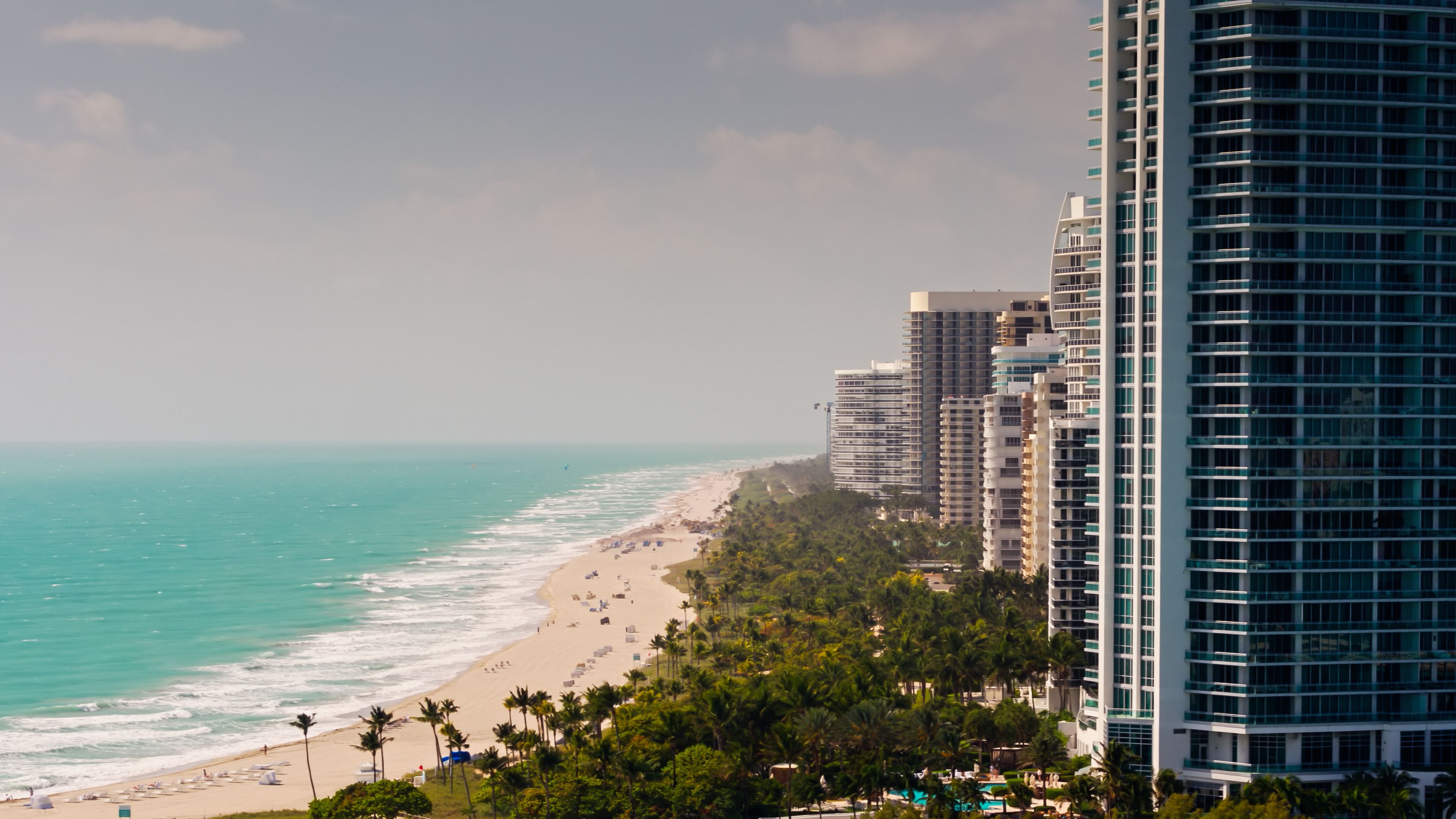 Drone Shot Looking Past Condo Tower Towards Bal Harbour Beach