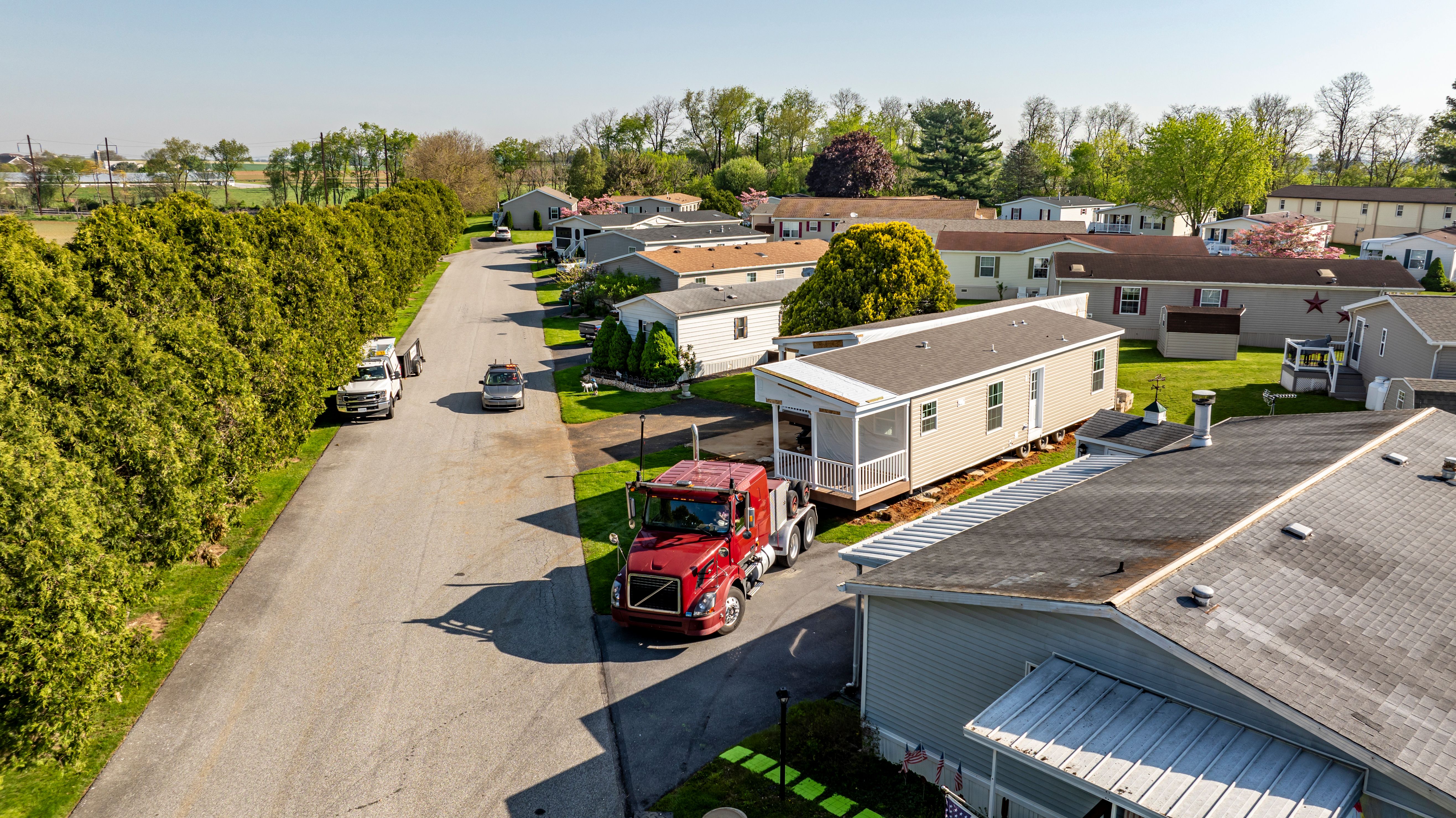 Aerial View of a Manufactured, Mobile, Prefab Double Wide Home Being Installed in a Lot in a Park Aerial View of a Manufactured, Mobile, Prefab Double Wide Home Being Installed in a Lot in a Park