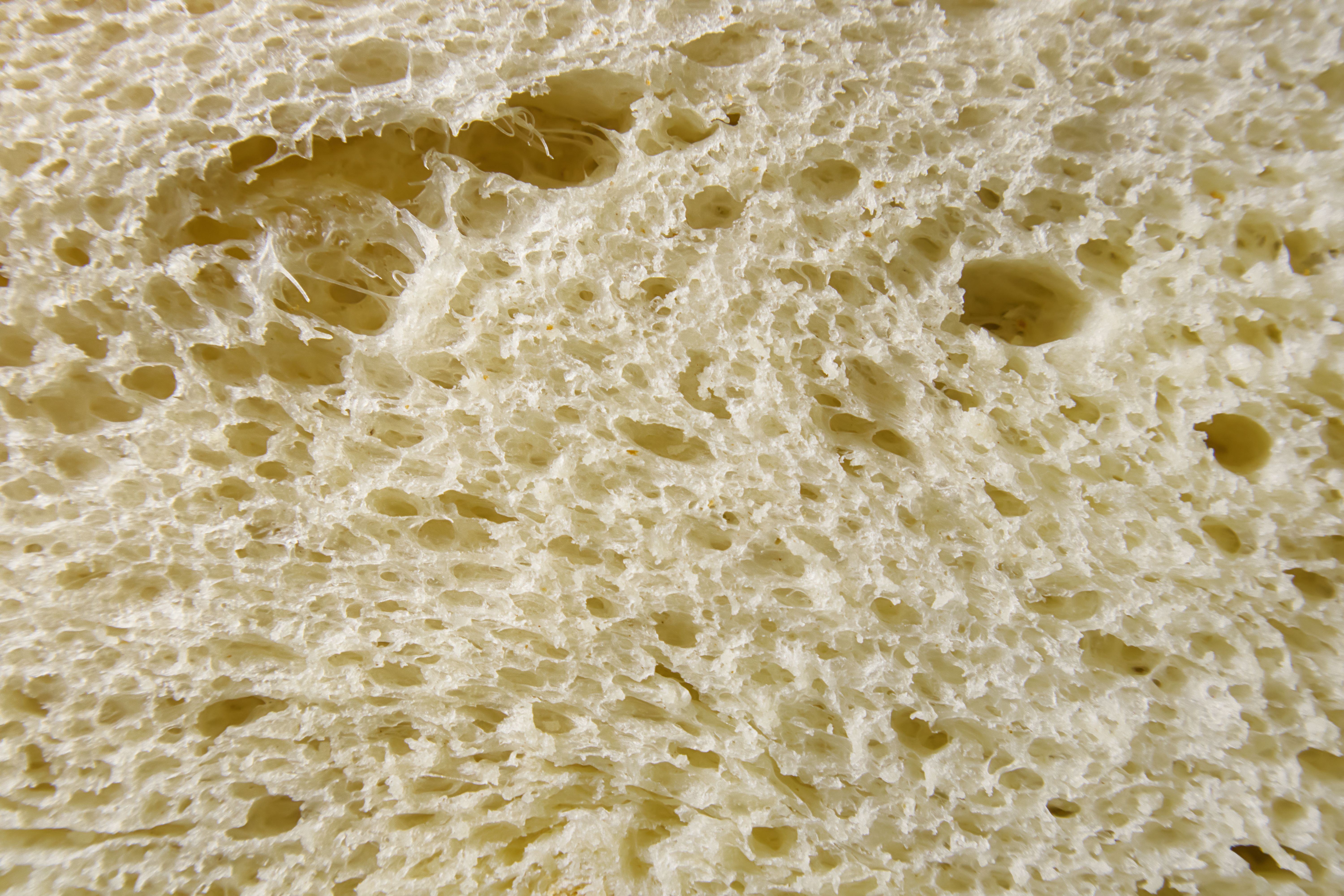 Slice of freshly baked wheat bread texture close up. Slice of freshly baked wheat bread texture close up.