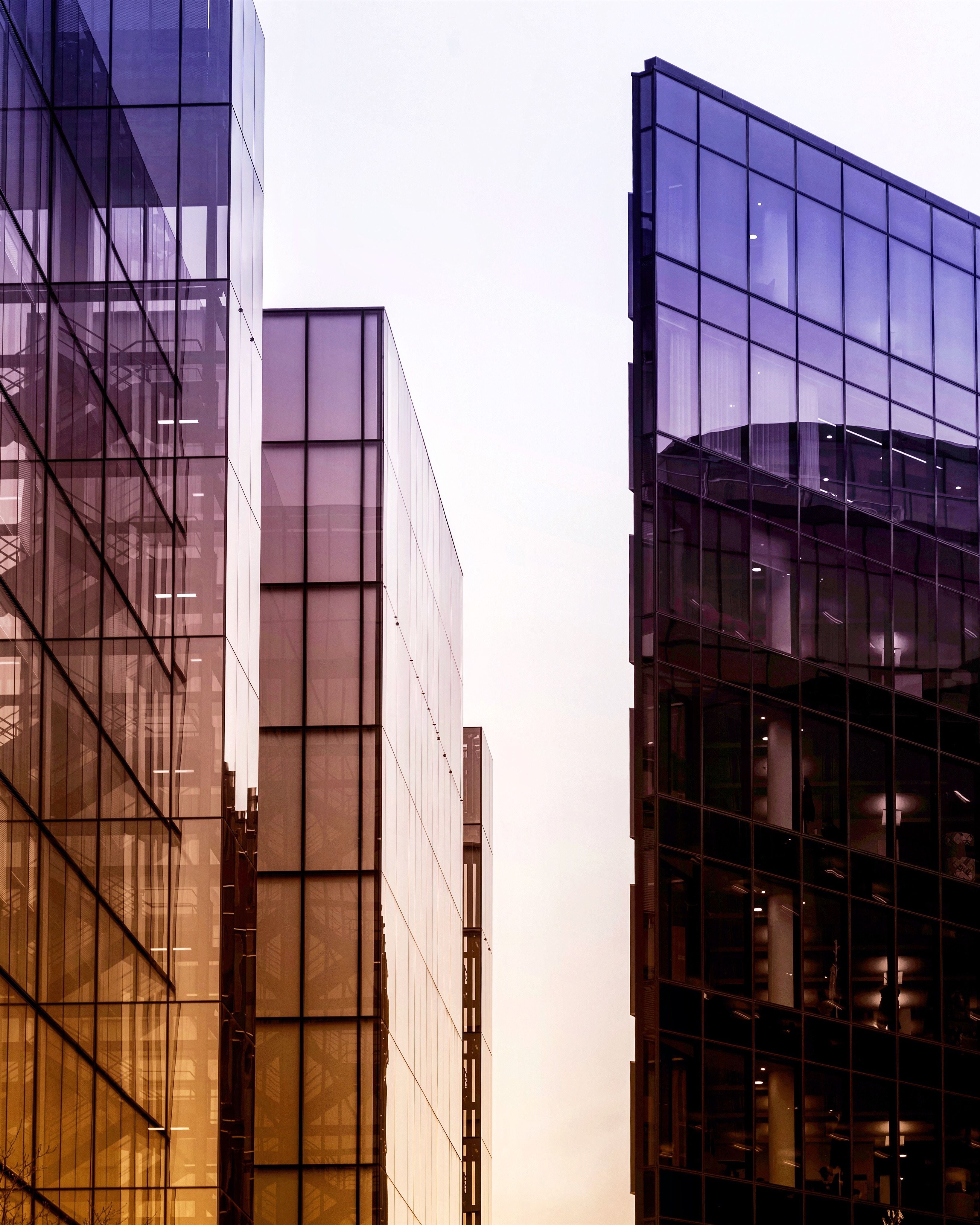 Vertical shot of high rise  buildings in a glass facade with reflective windows
