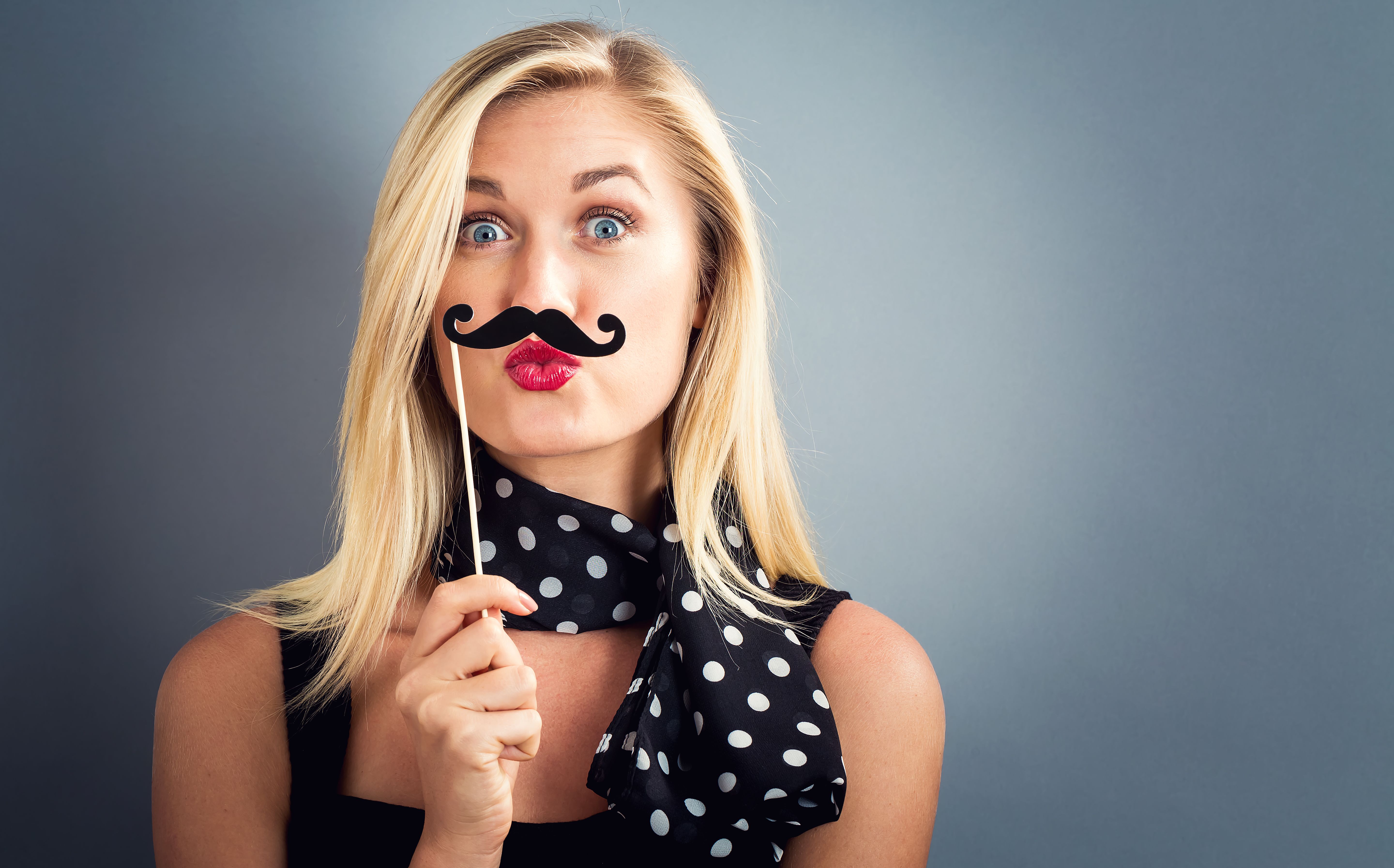 Young woman holding paper party sticks