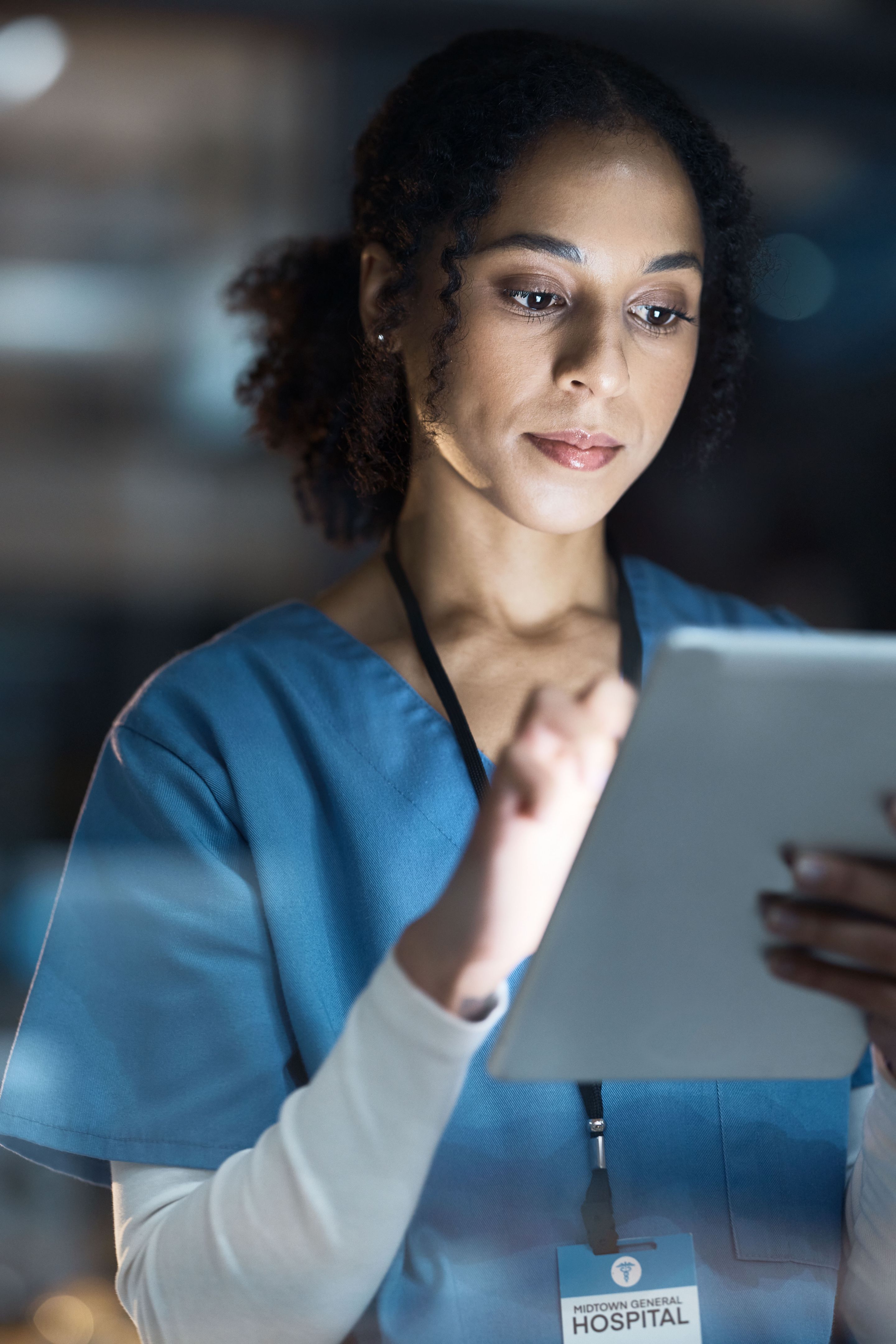nurse studying on tablet