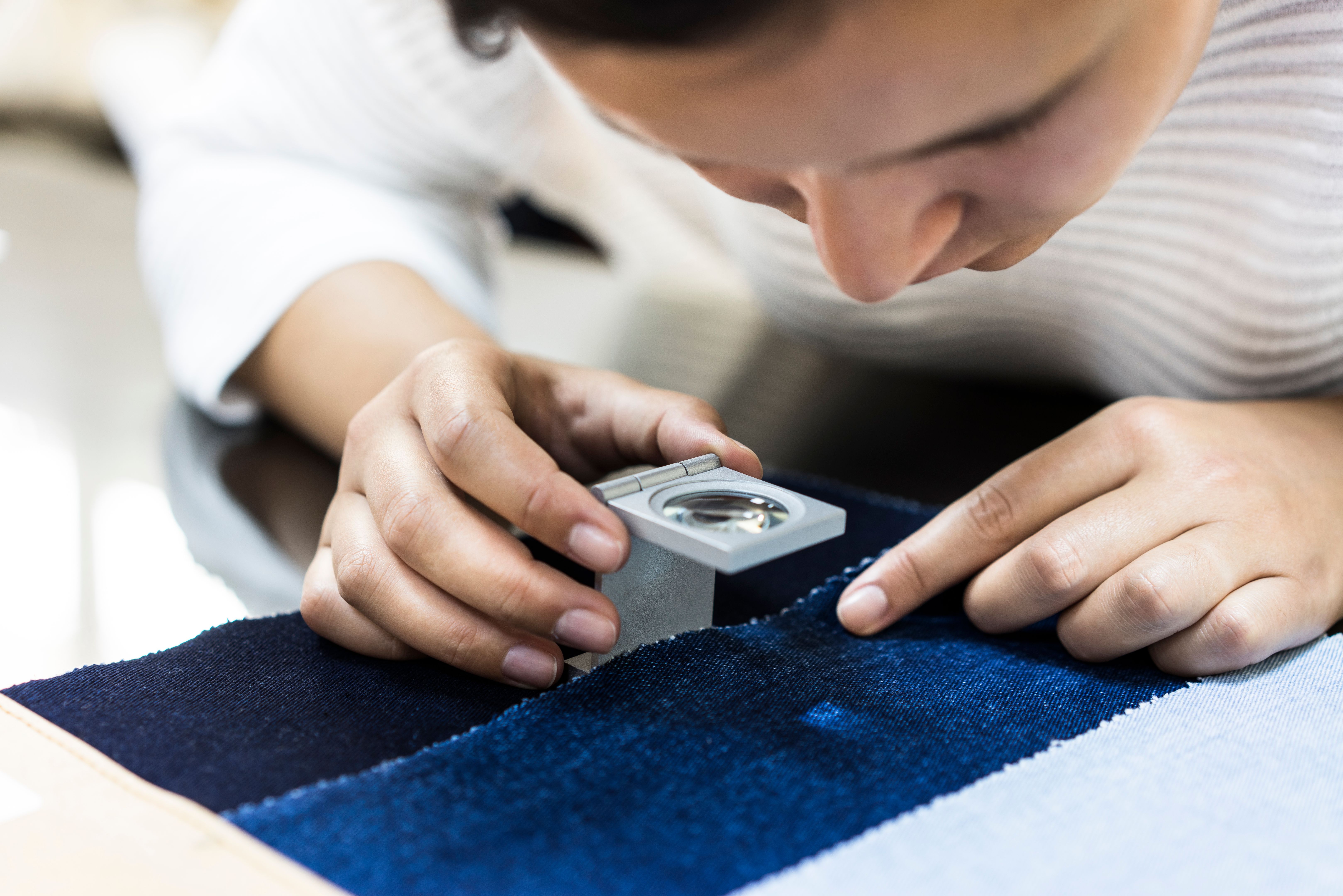 Woman examining fabric quality Woman examining fabric quality