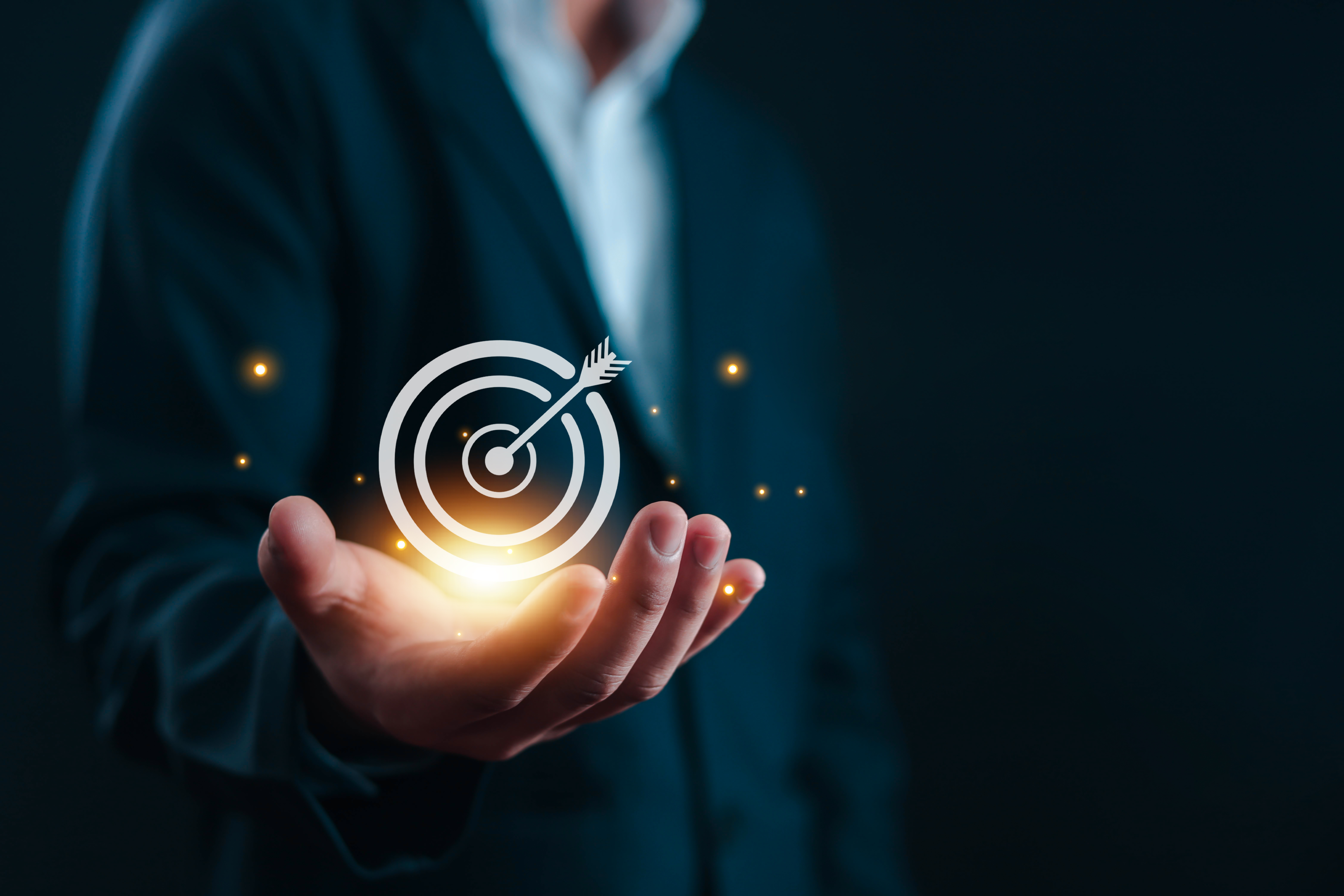 Businessman holding target icon