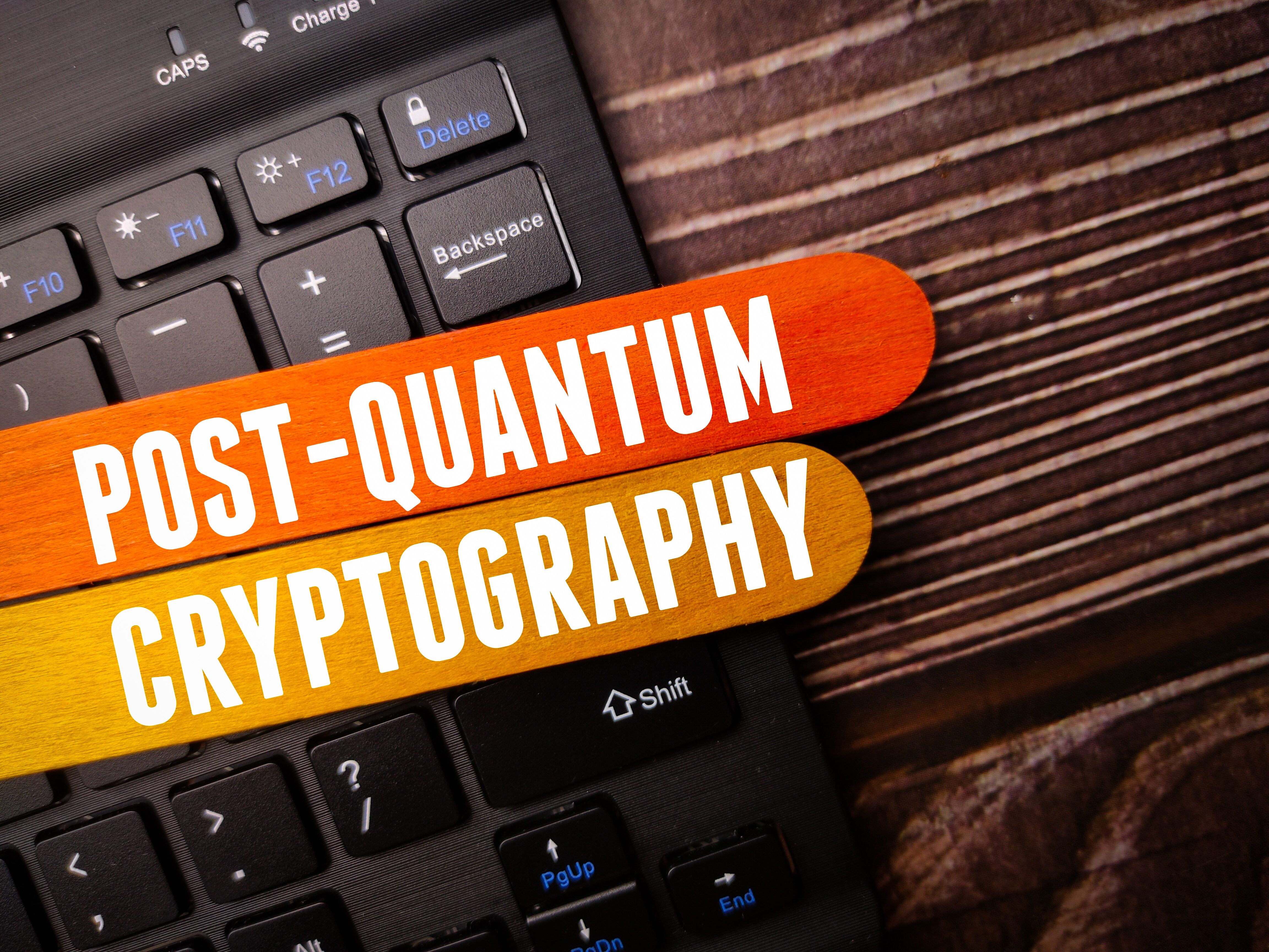 Black keyboard with the word POST QUANTUM CRYPTOGRAPHY on a wooden background Black keyboard with the word POST QUANTUM CRYPTOGRAPHY on a wooden background