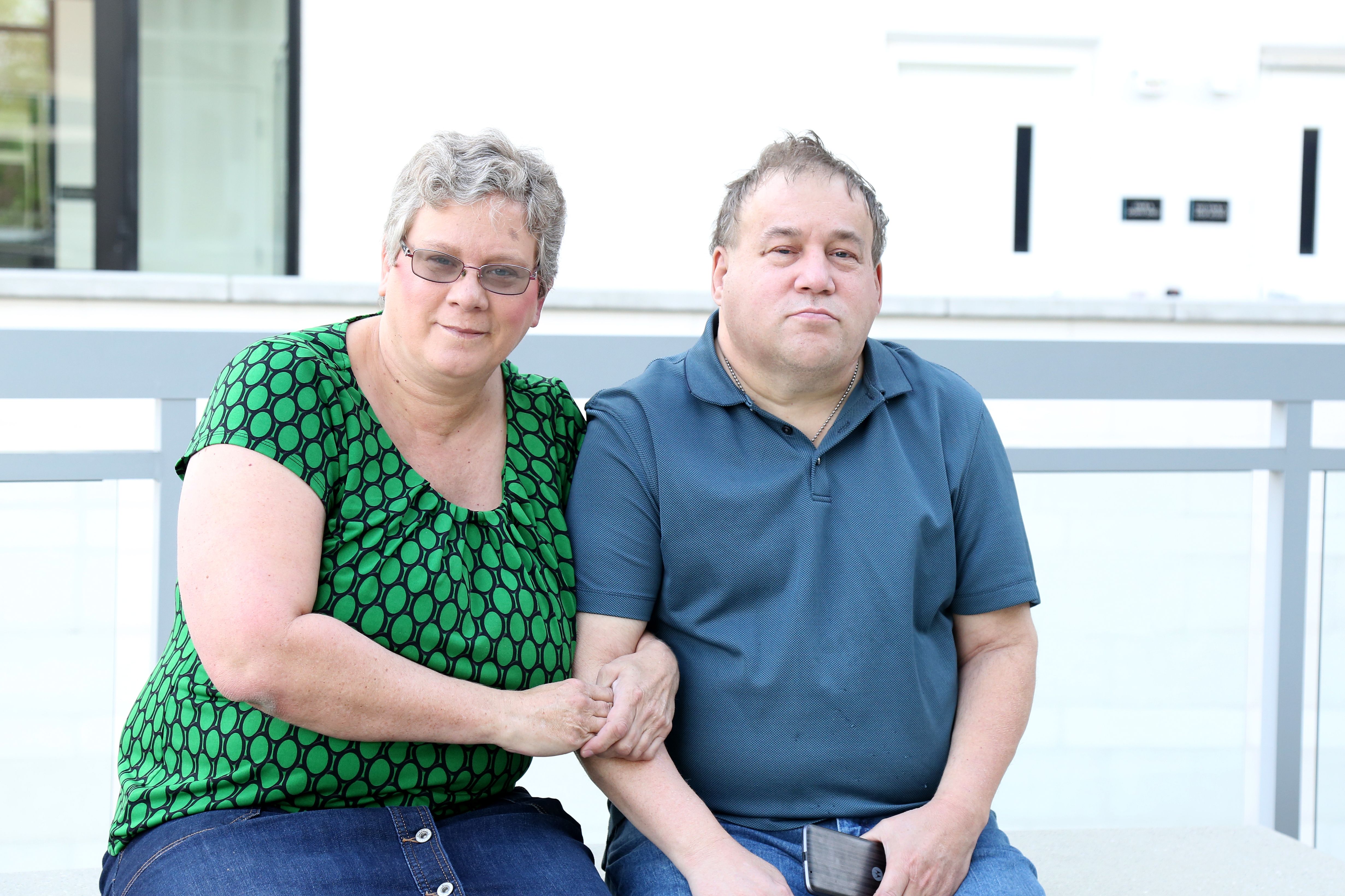 Mature adult female sits next to her Autistic brother Mature adult female sits next to her Autistic brother