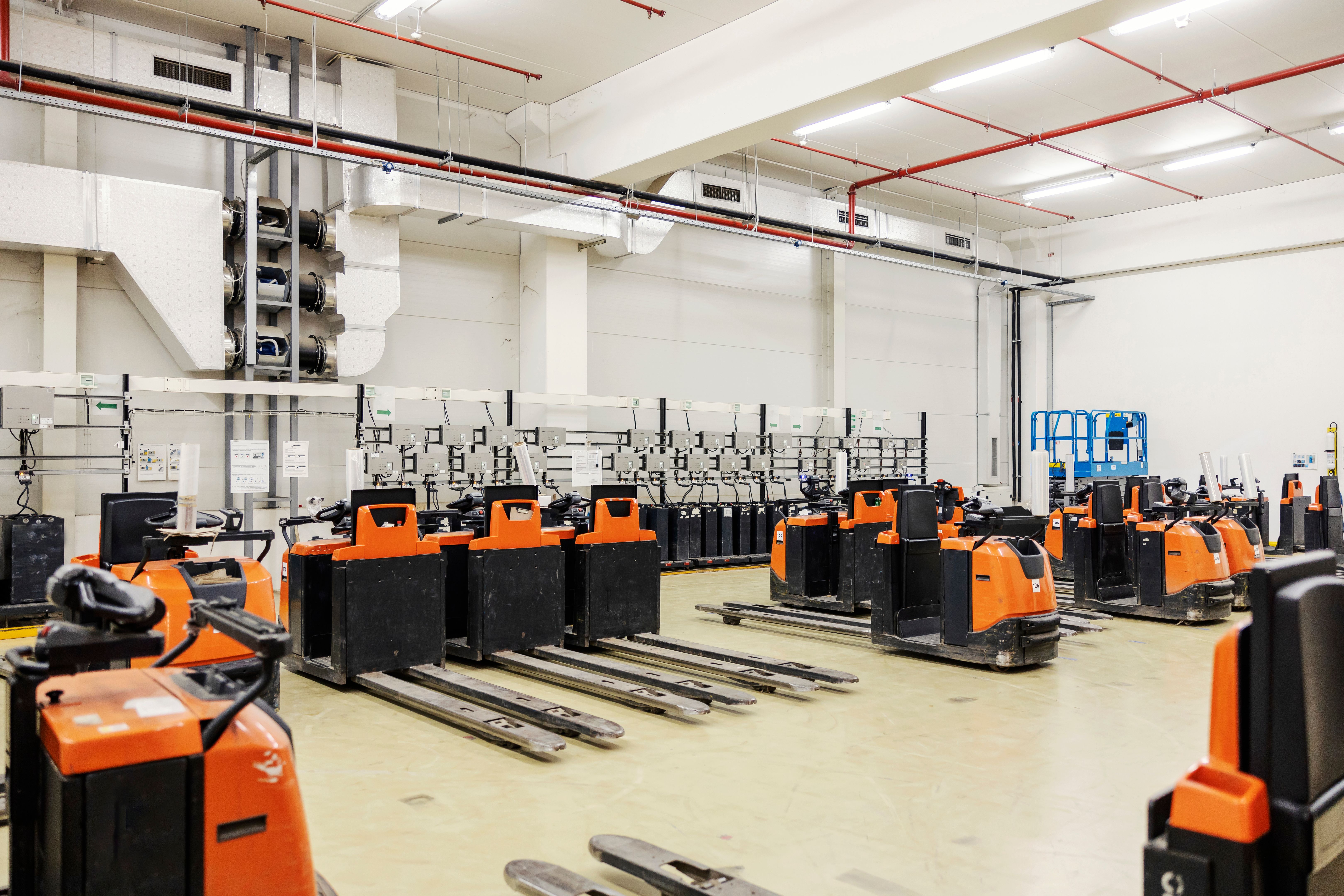 Forklifts and vehicles on battery chargers.