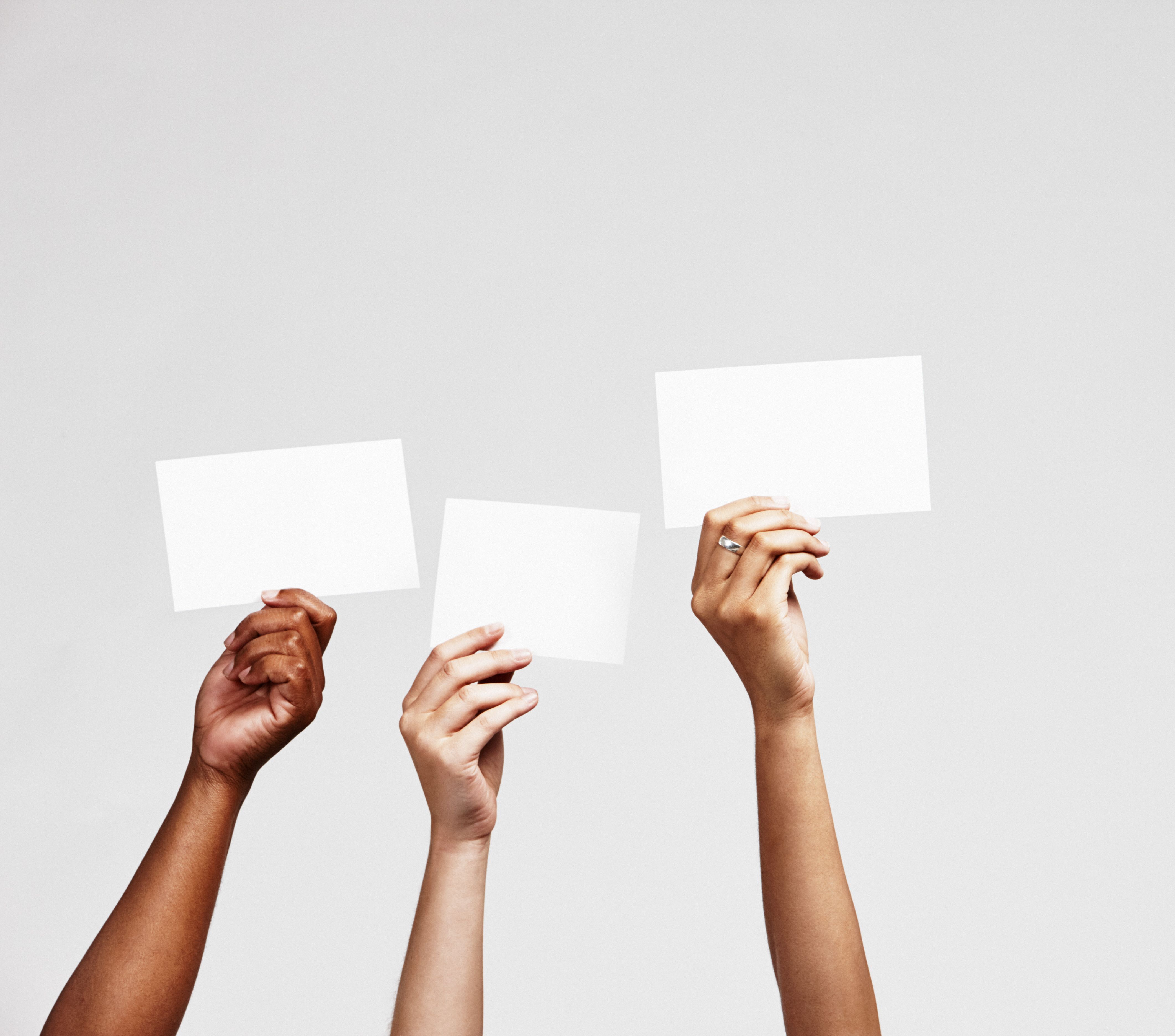 Diverse hands holding up blank signs