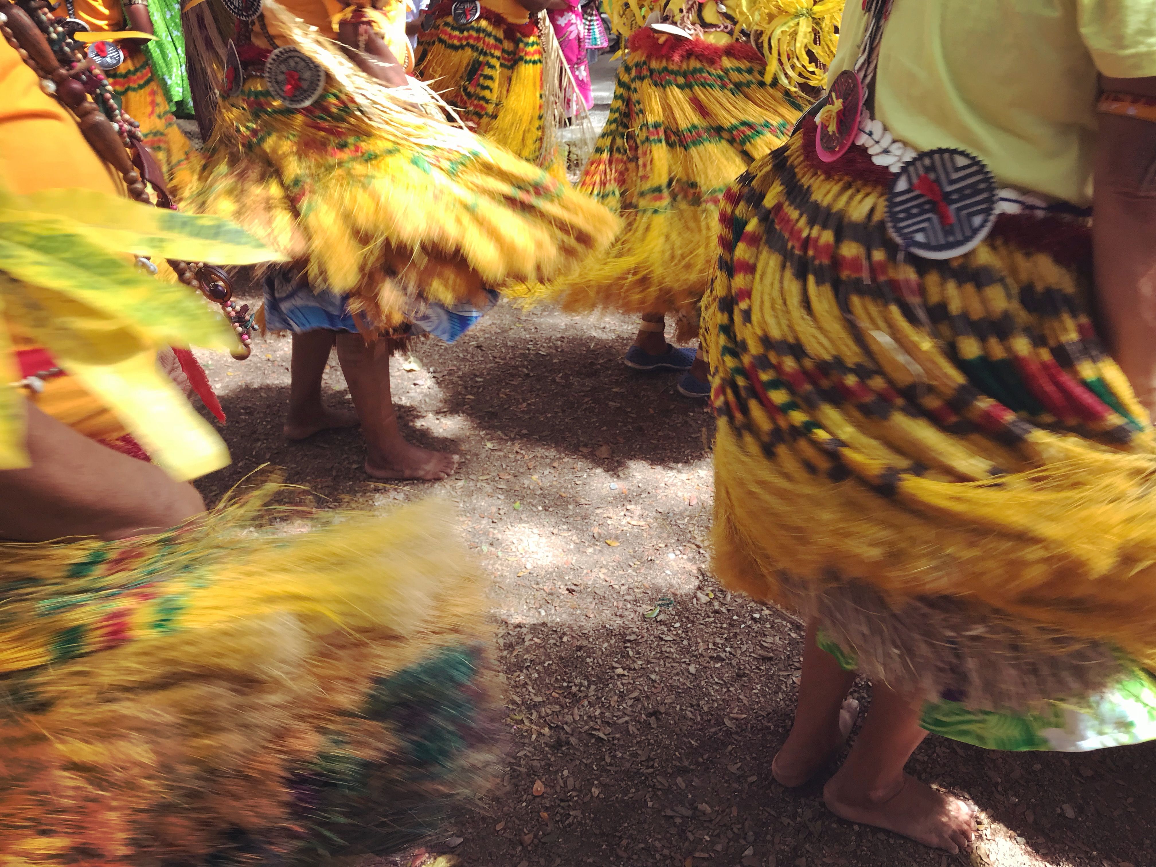 The swirling of yellow skirts during a traditional barefoot dance in Papua New Guinea