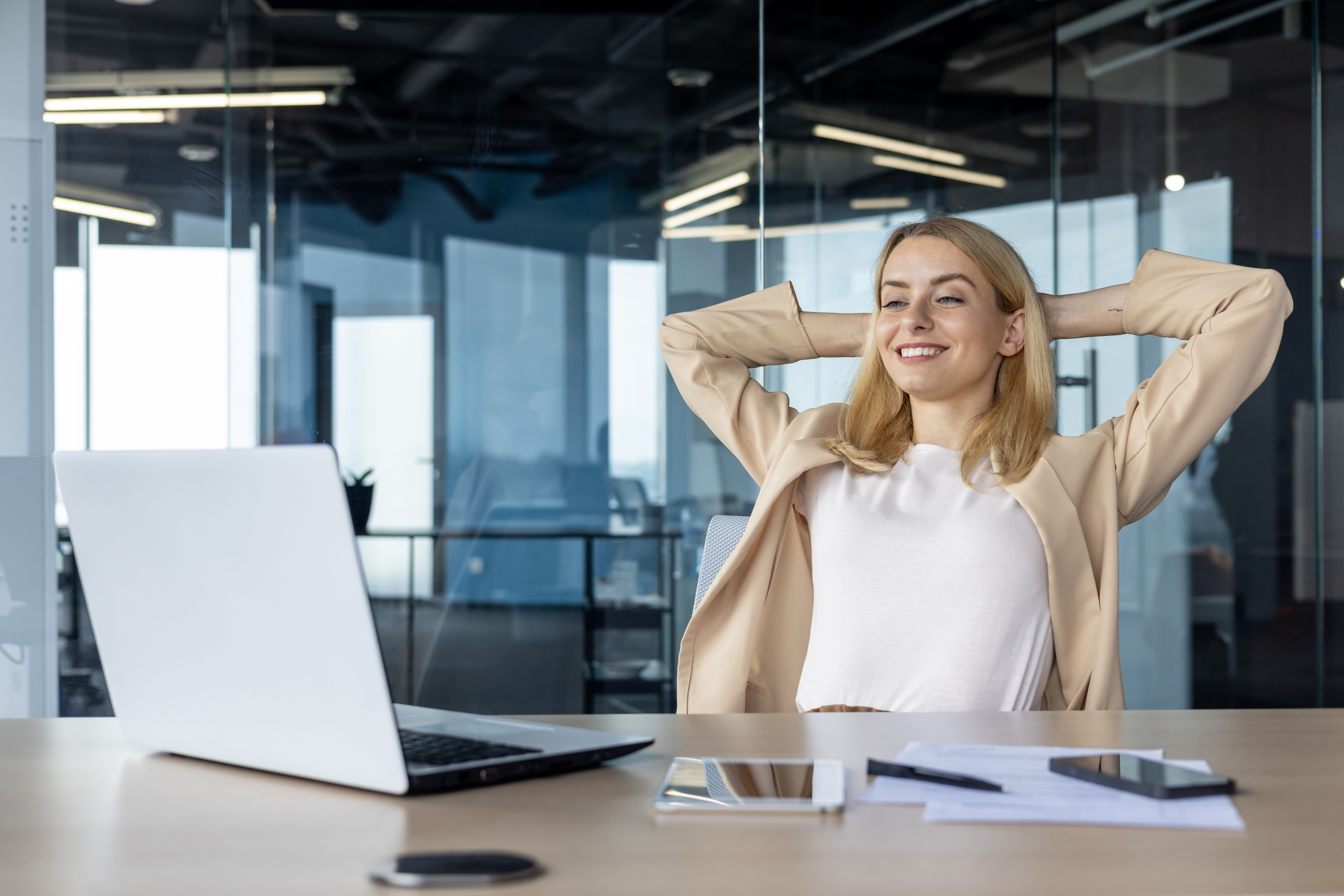 Confident businesswoman relaxing in a modern office space Confident businesswoman relaxing in a modern office space