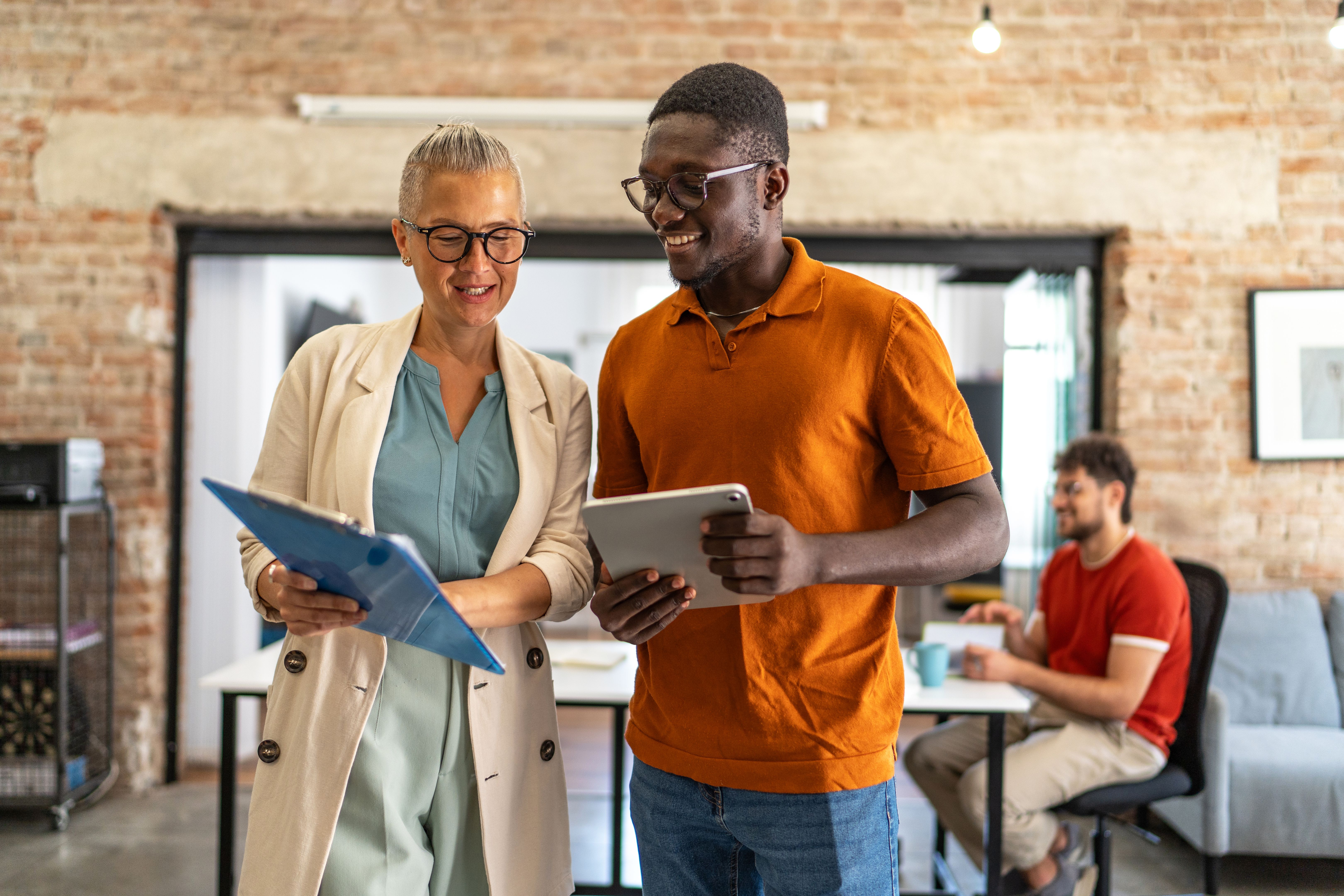 Diverse business colleagues collaborating on project in modern office Diverse business colleagues collaborating on project in modern office