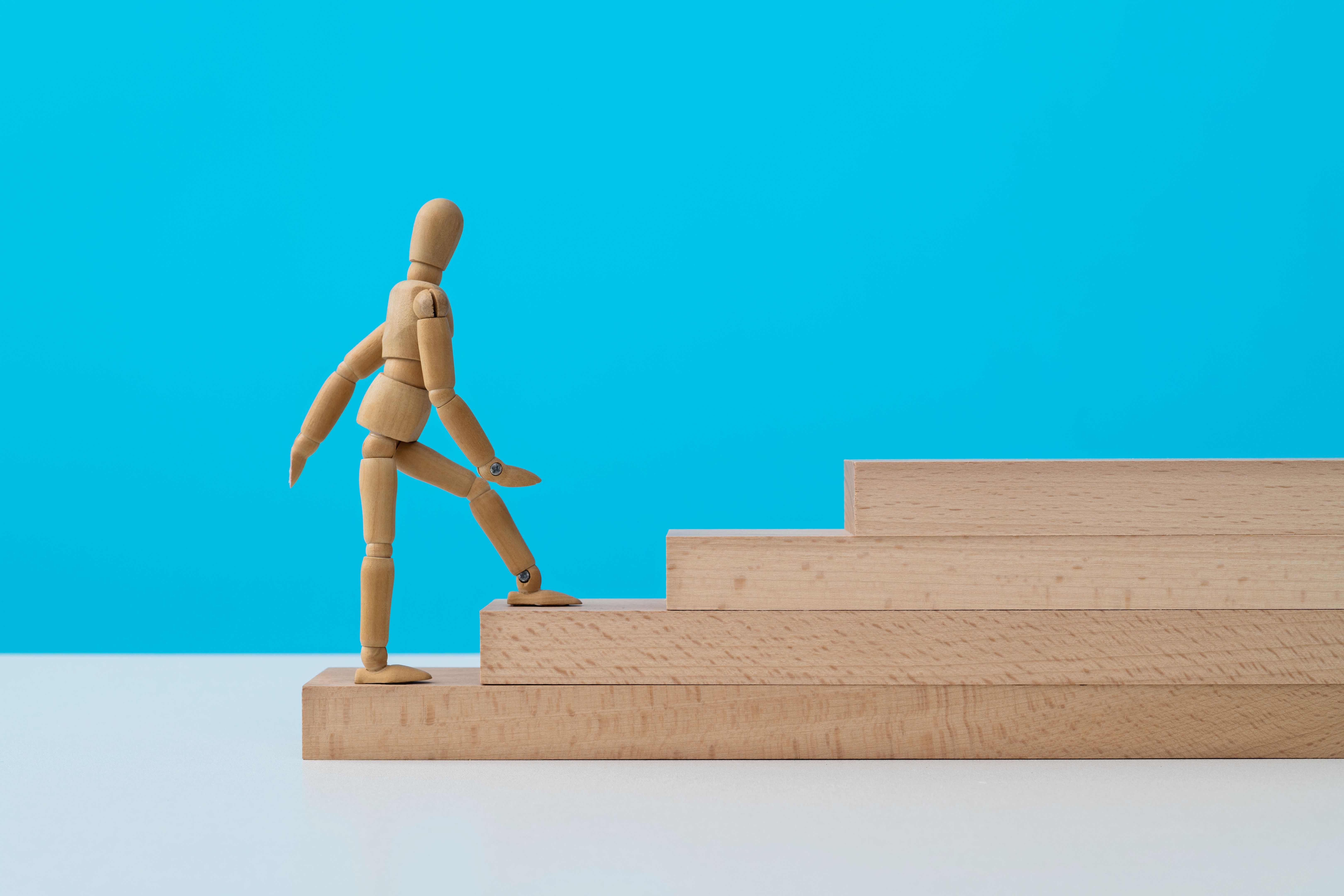 Wooden puppet climbing block stairs