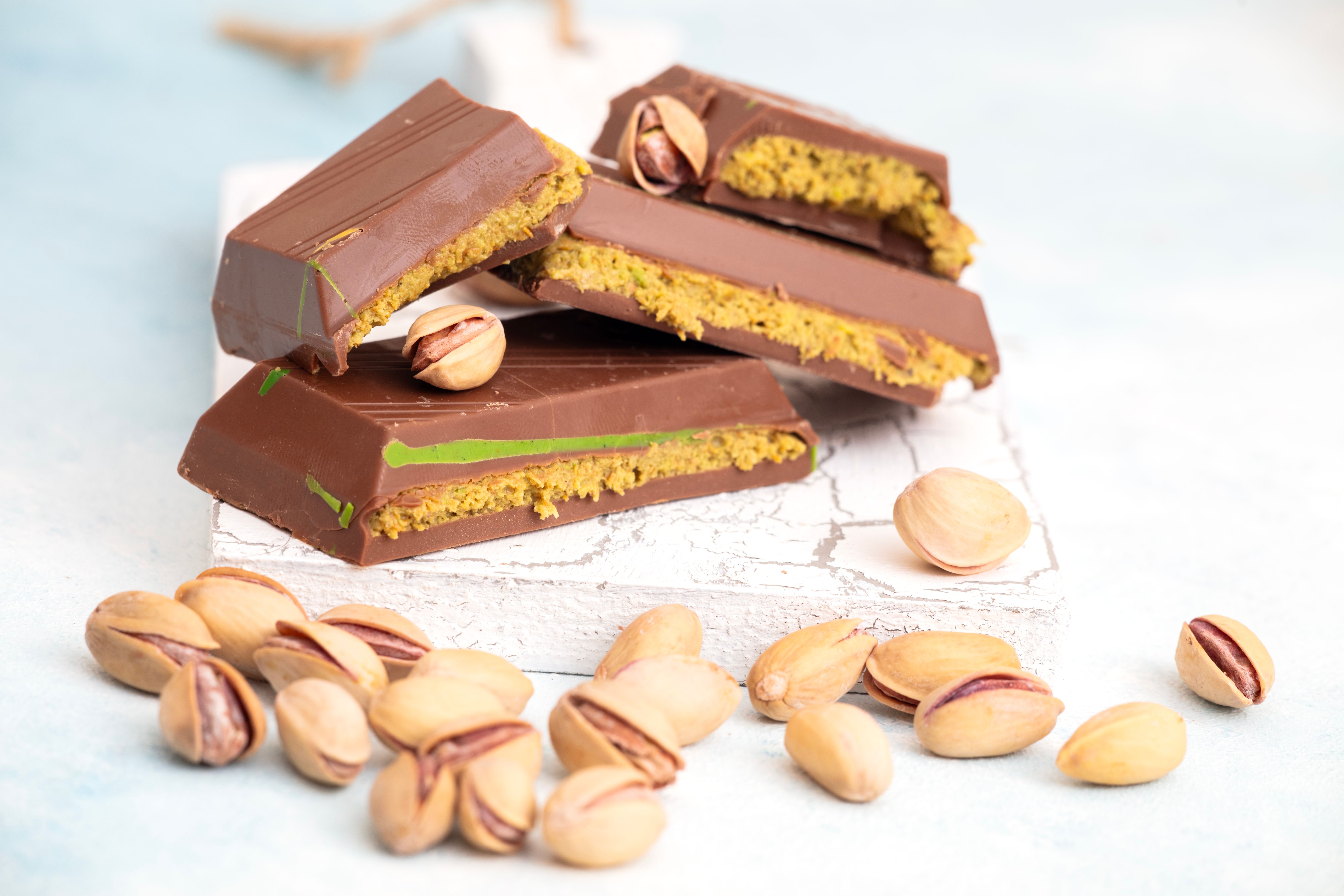 Dubai Chocolate bar with green kadayif and pistachio spread with pistachio nuts Dubai Chocolate bar with green kadayif and pistachio spread with pistachio nuts