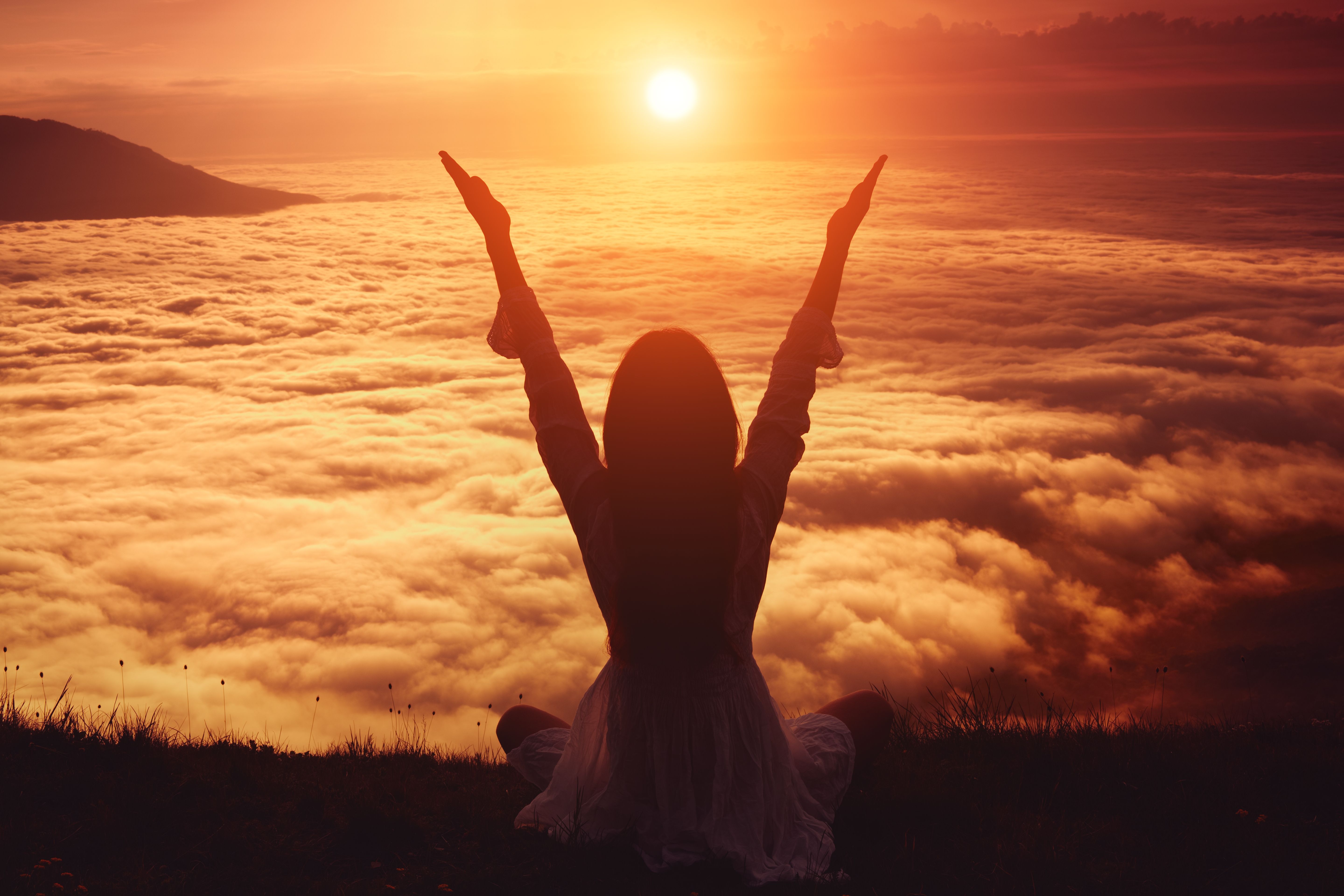 Woman lifting her arms in immense joy