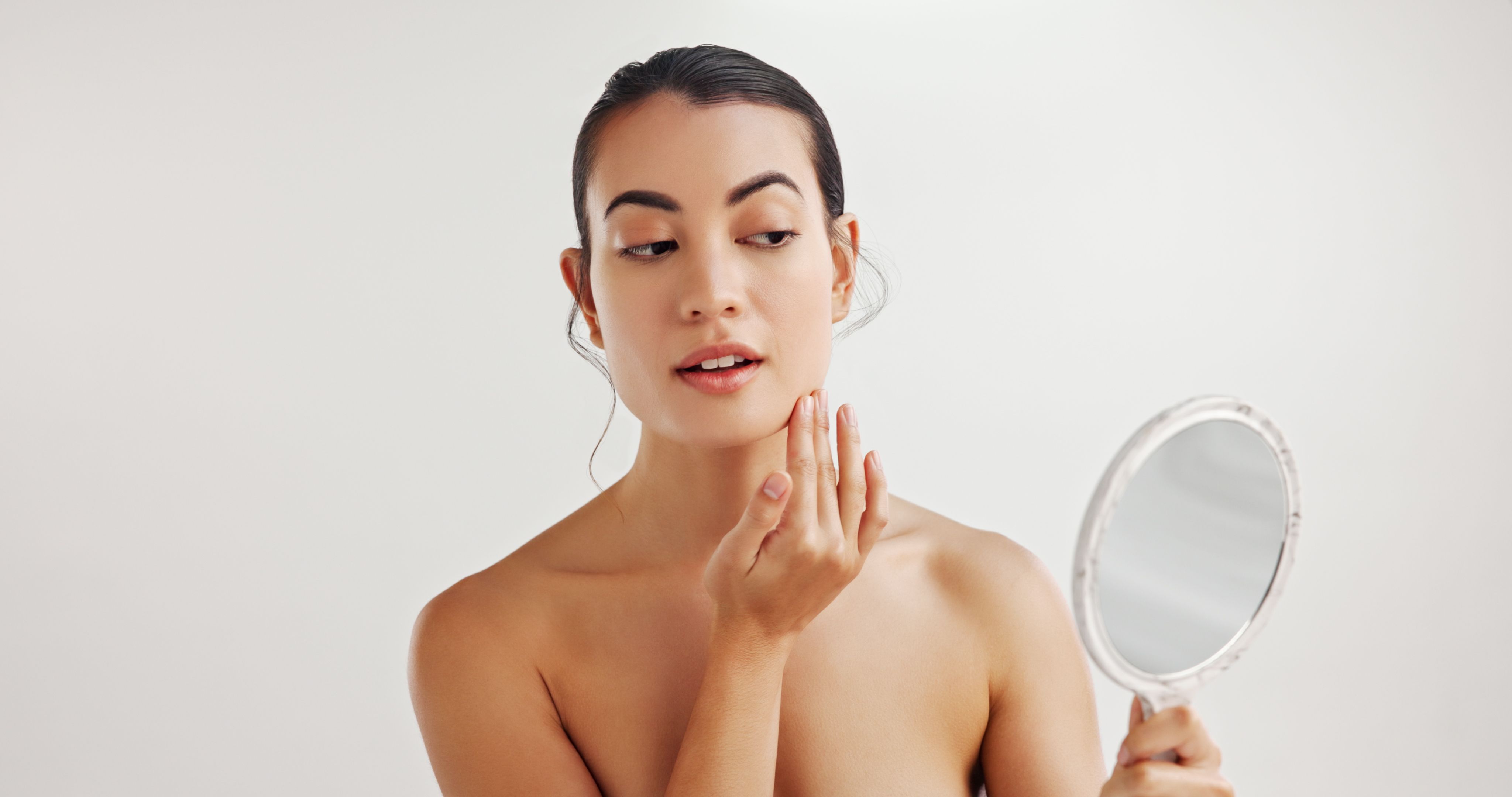 woman examining skin