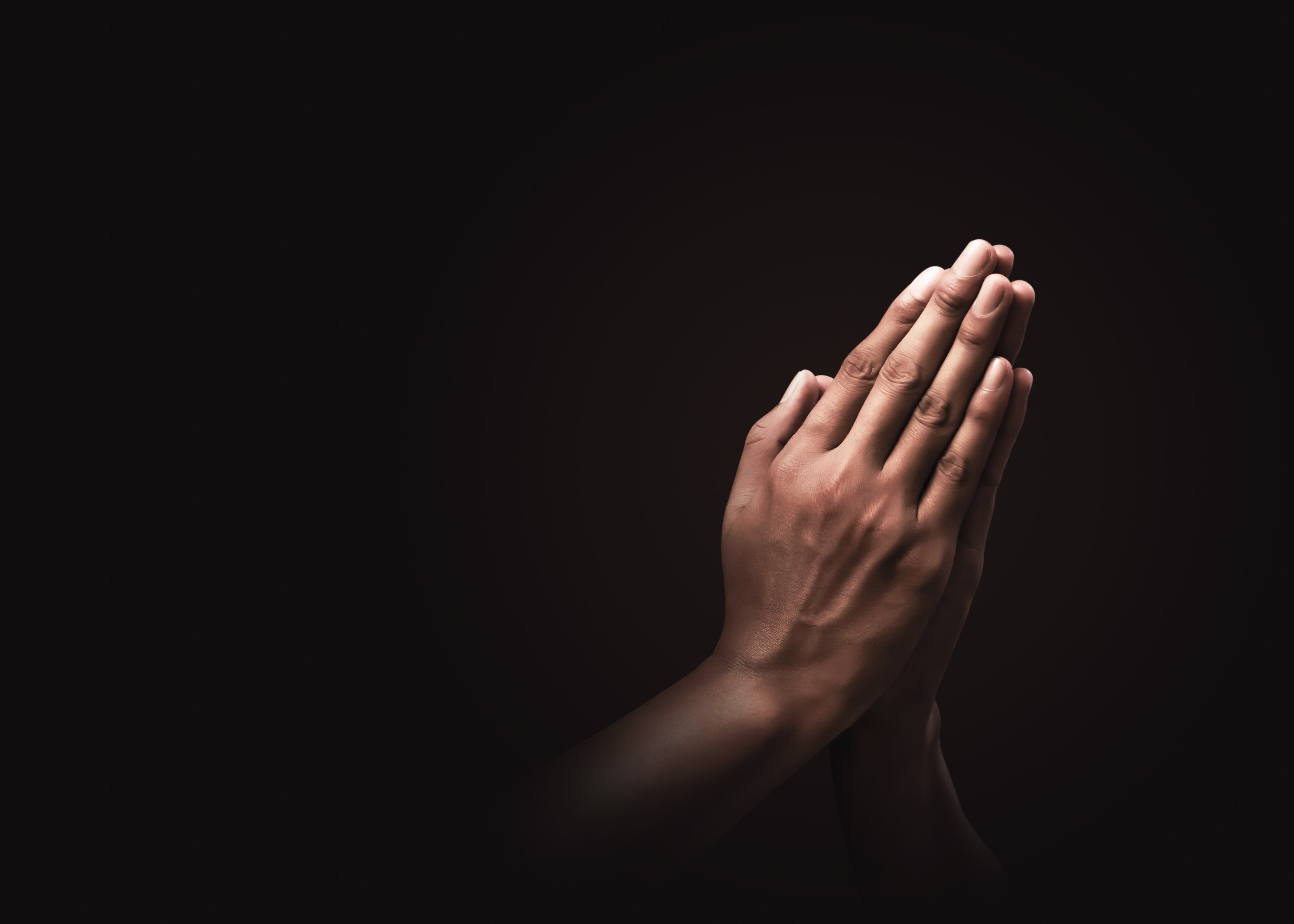 Praying hands with faith in religion and belief in God on dark background. Power of hope or love and devotion. Namaste or Namaskar hands gesture. Prayer position. Praying hands with faith in religion and belief in God on dark background. Power of hope or love and devotion. Namaste or Namaskar hands gesture. Prayer position.