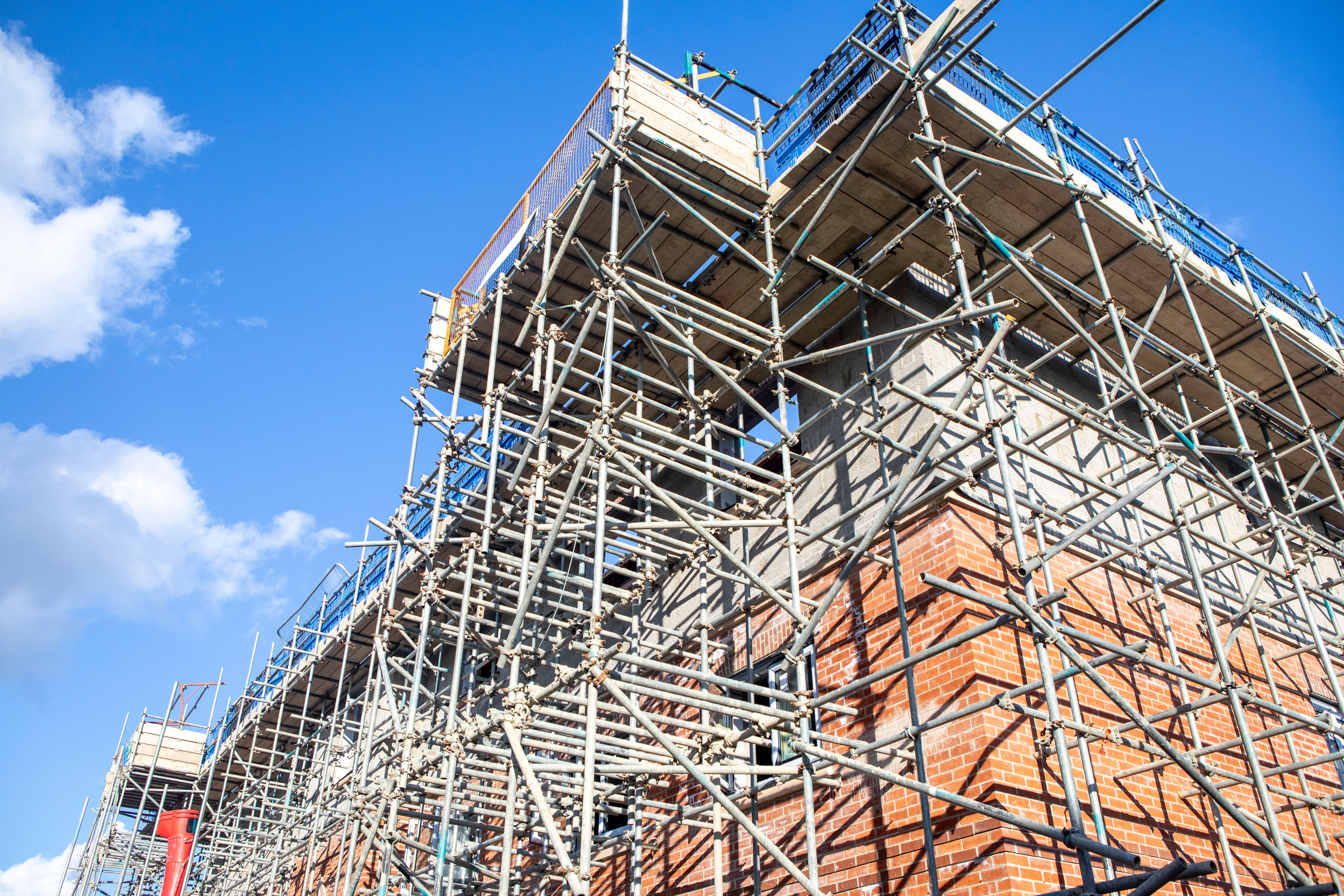 New houses under construction and surrounded in scaffolding New houses under construction and surrounded in scaffolding