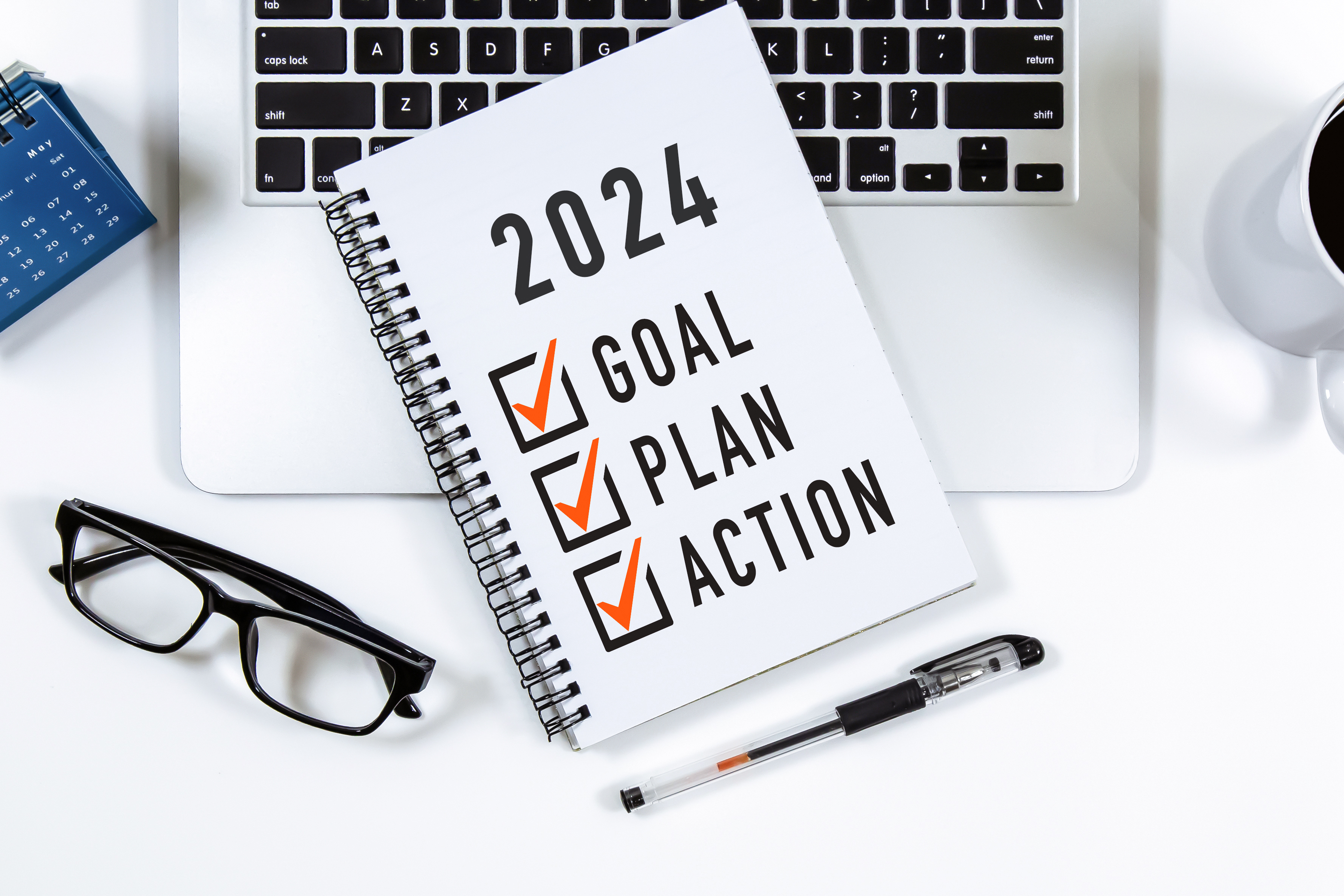 2024 Goal, Plan, Action checklist text on note pad with laptop, glasses and pen. 2024 Goal, Plan, Action checklist text on note pad with laptop, glasses and pen.