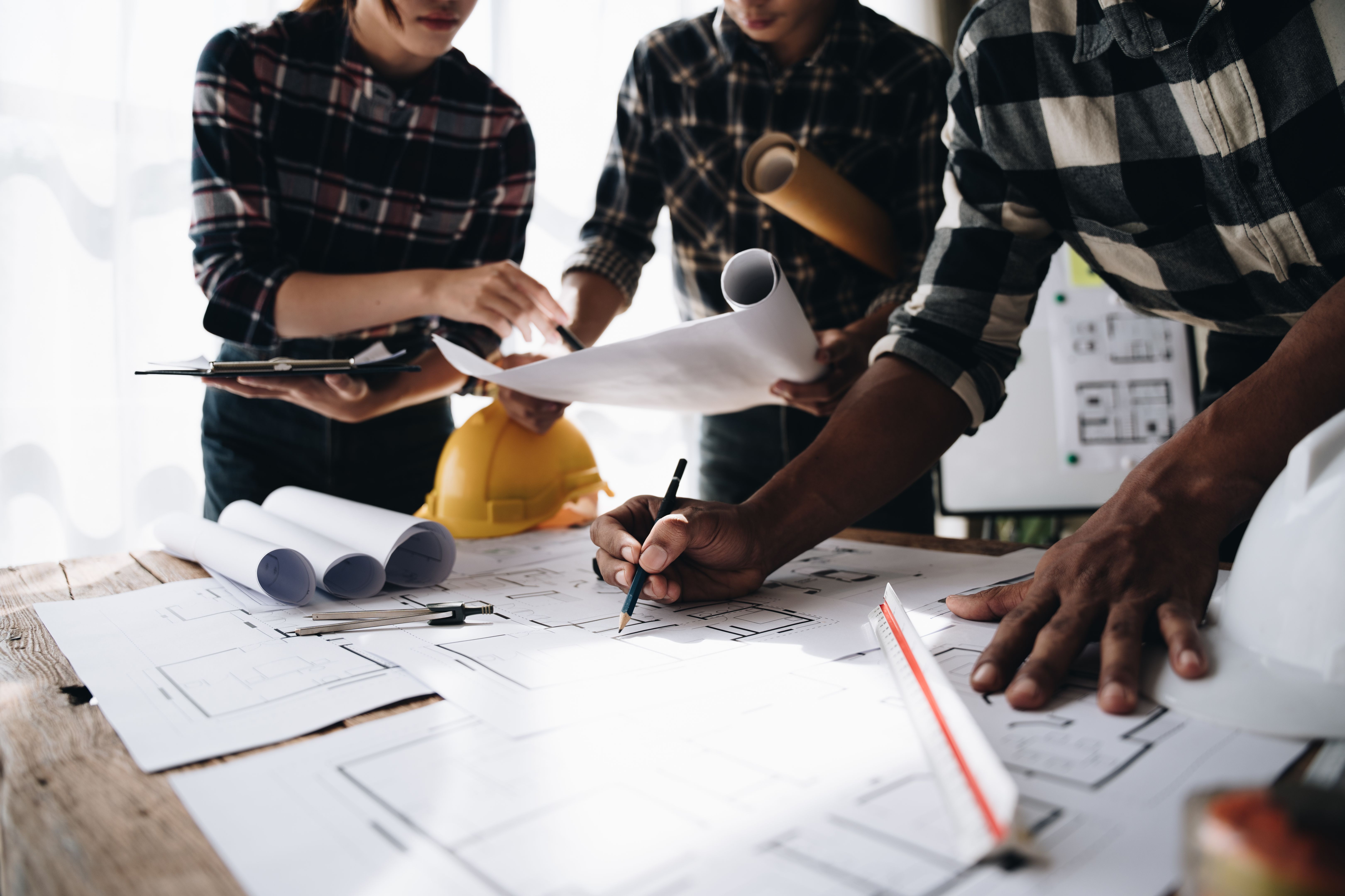 Confident team of engineers working together in a architect studio.