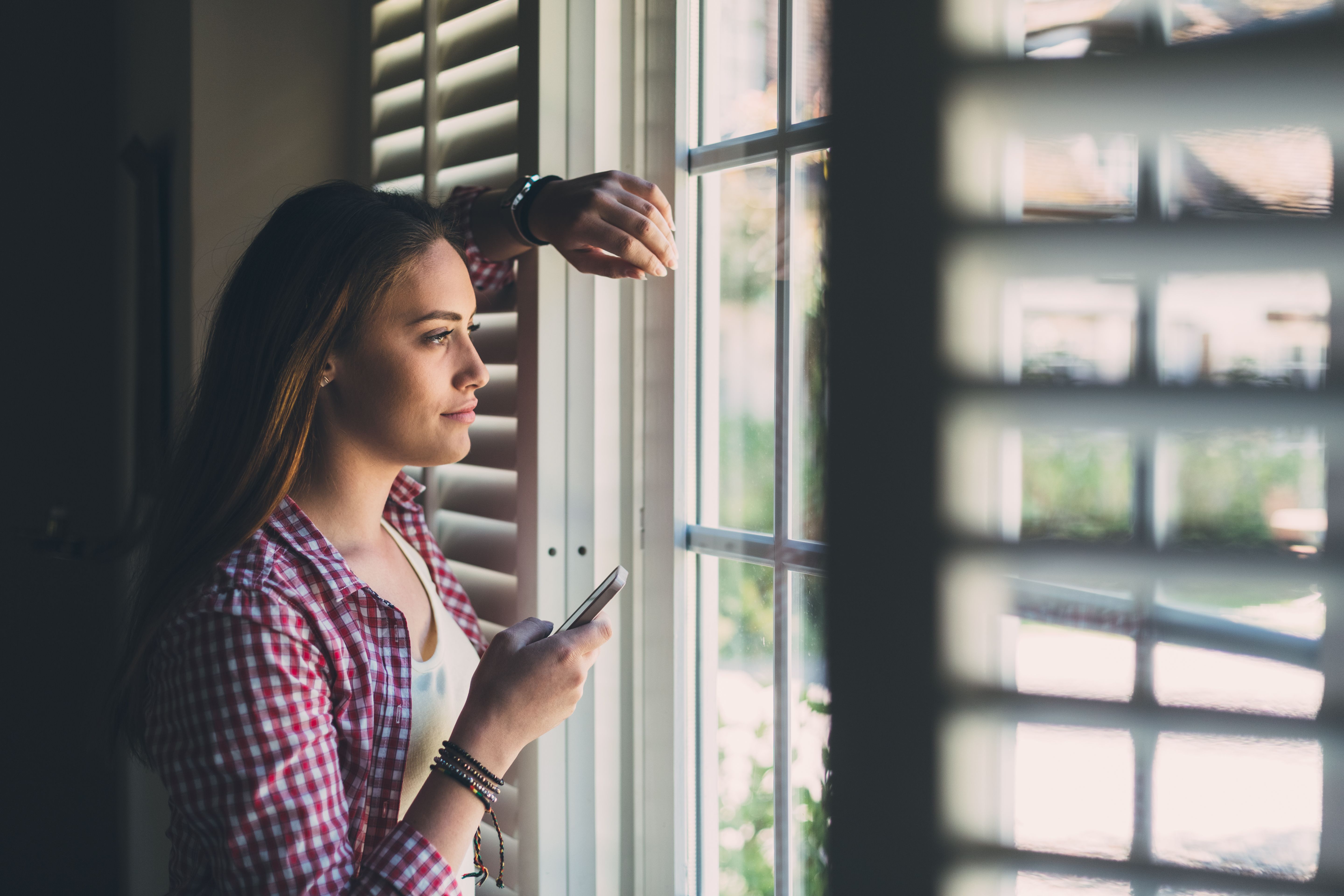 Cute girl looking through the window