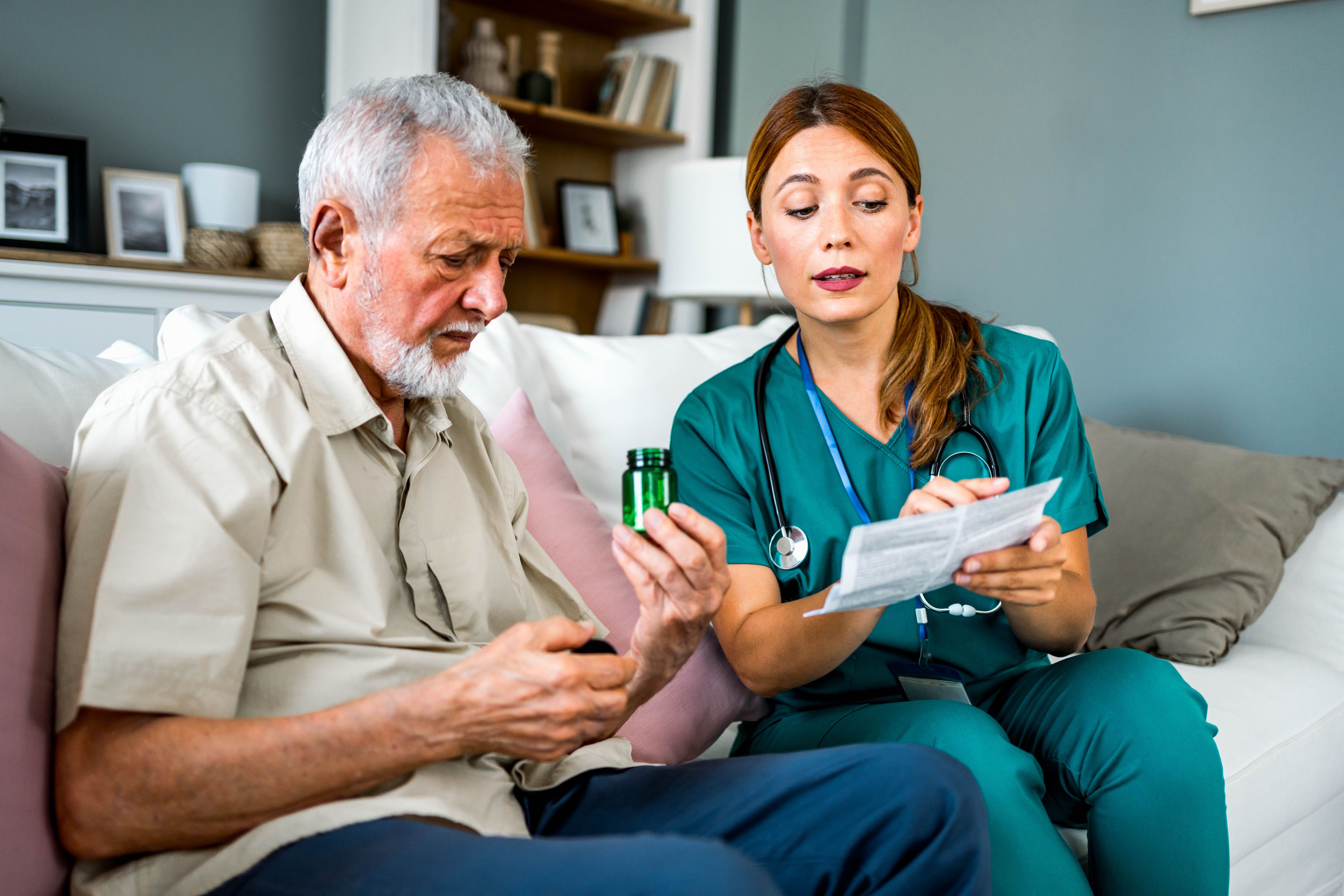 Nurse giving instructions to senior patient when to take his pills