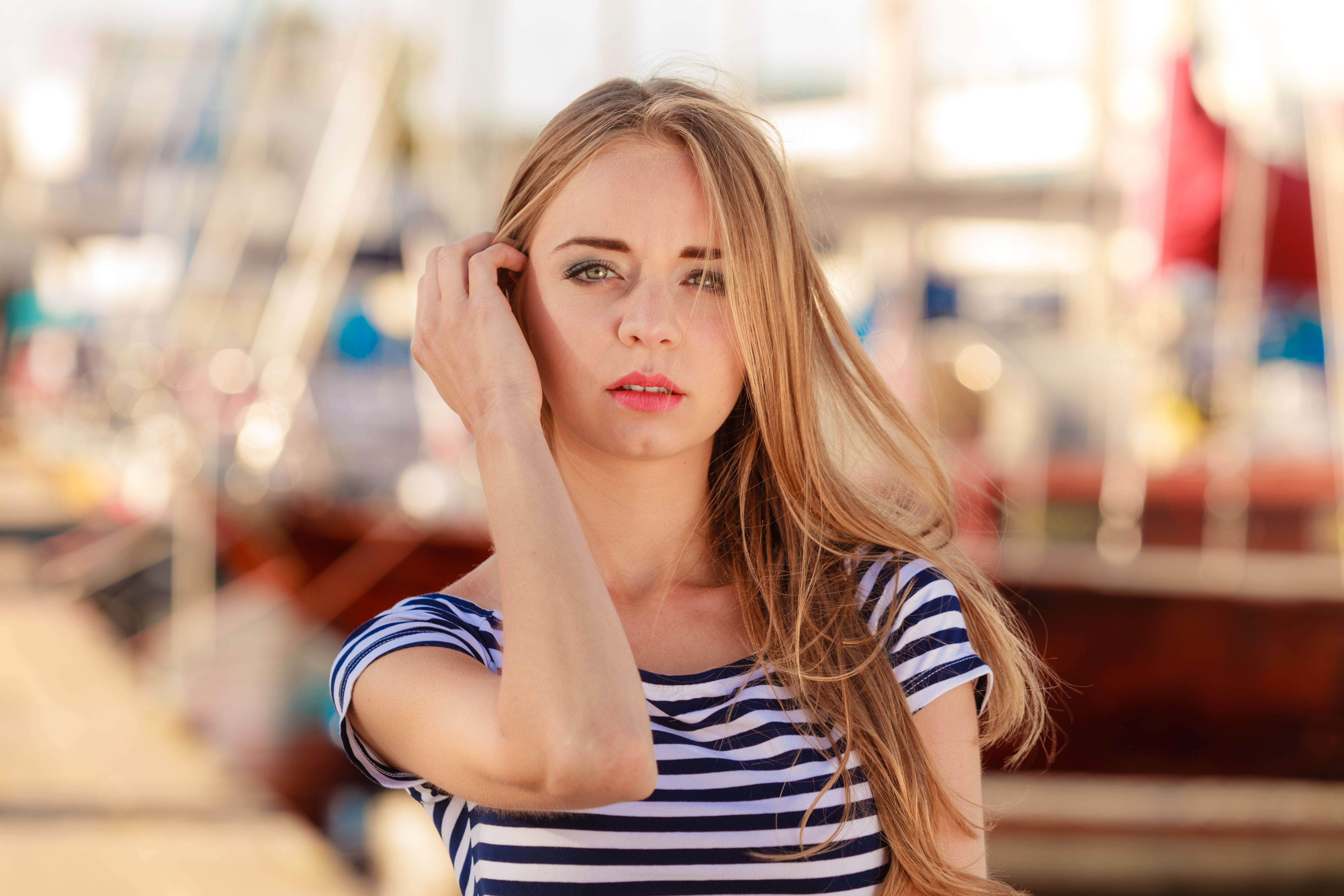 Girl enjoying summer breeze at sunset in marina