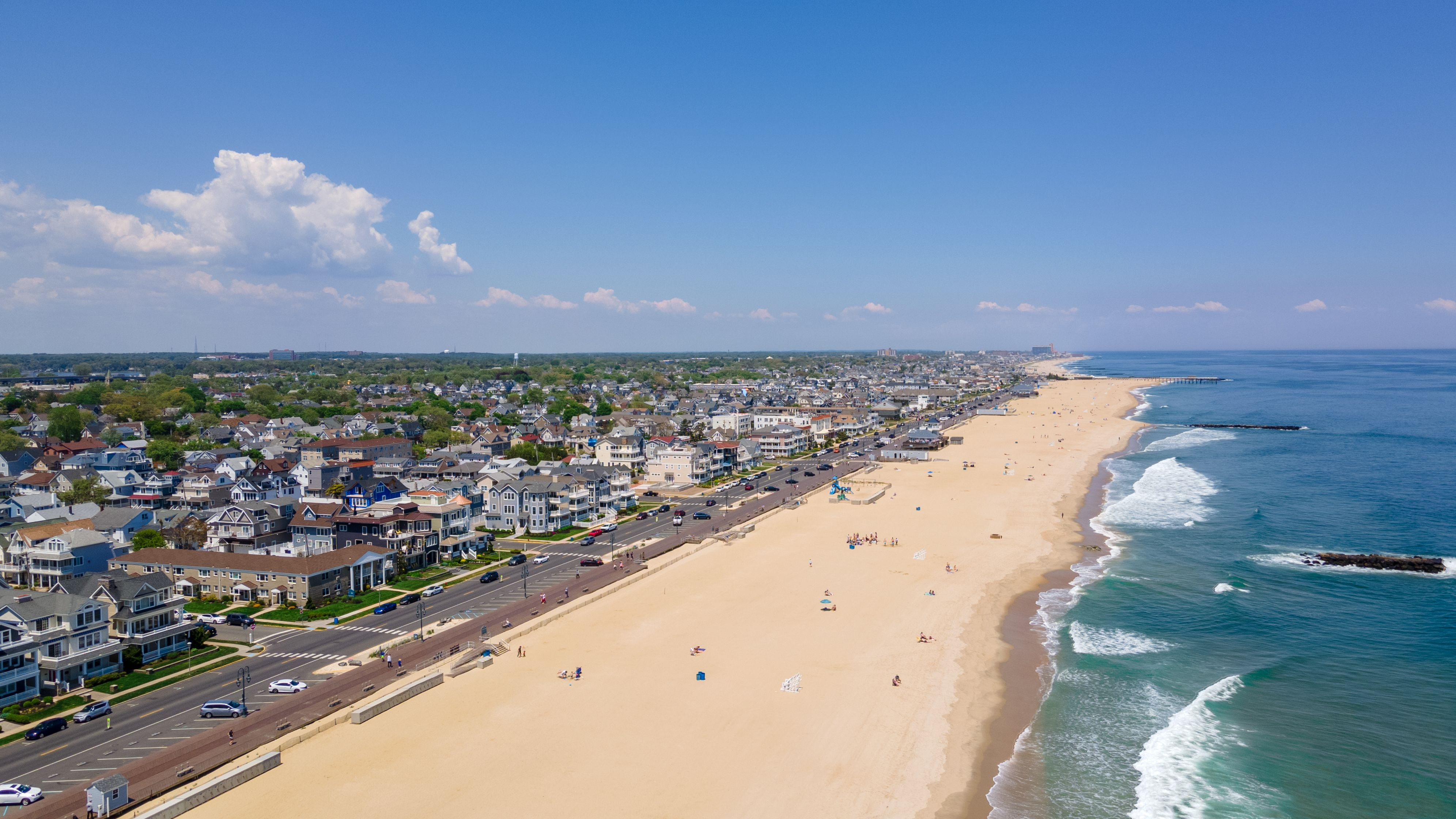 Drone shot of the Belmar Beach and coastal road and buildings on a sunny day in Belmar, New Jersey Drone shot of the Belmar Beach and coastal road and buildings on a sunny day in Belmar, New Jersey