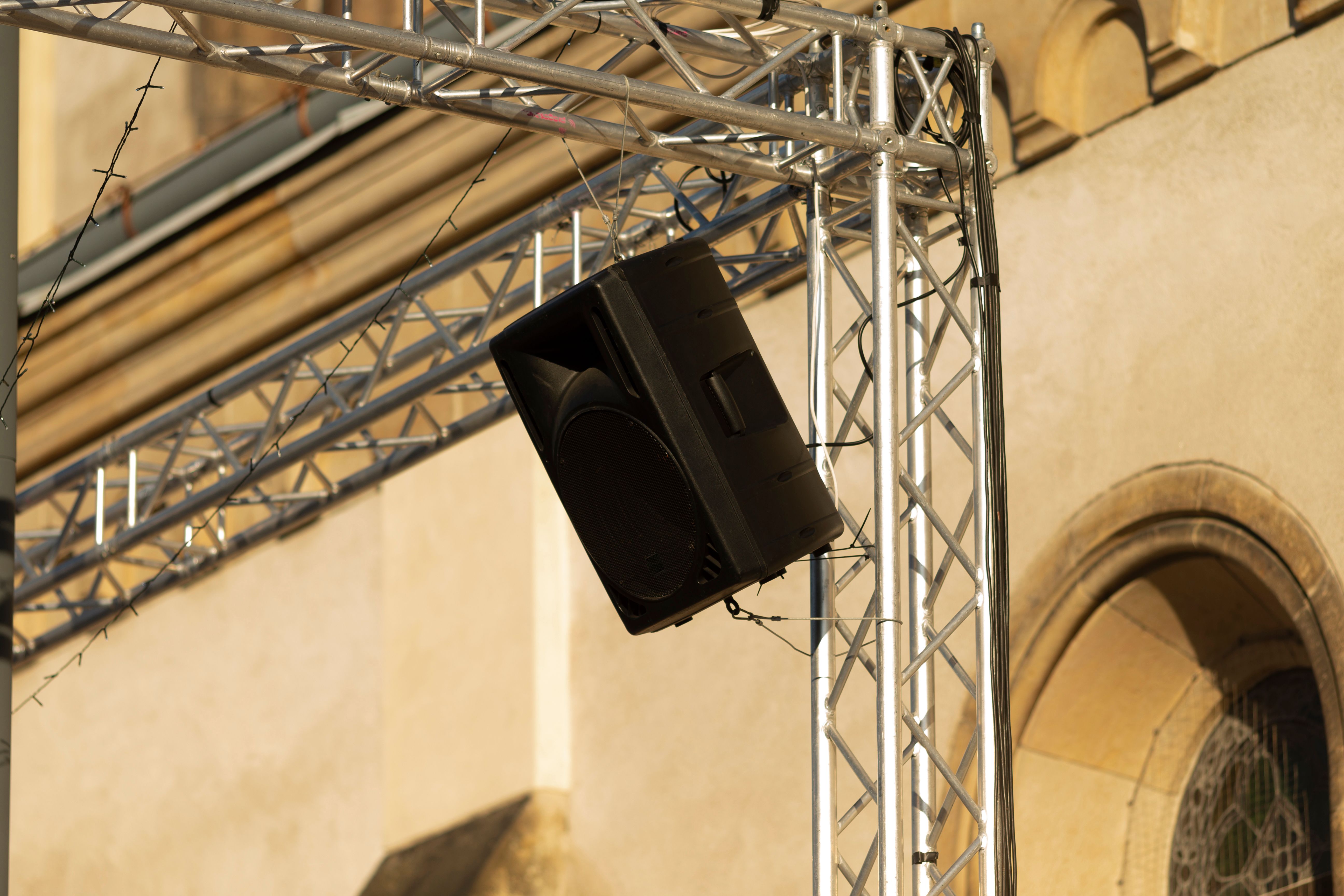 An Outdoor Speaker is Mounted on a Structure Located Near the Building