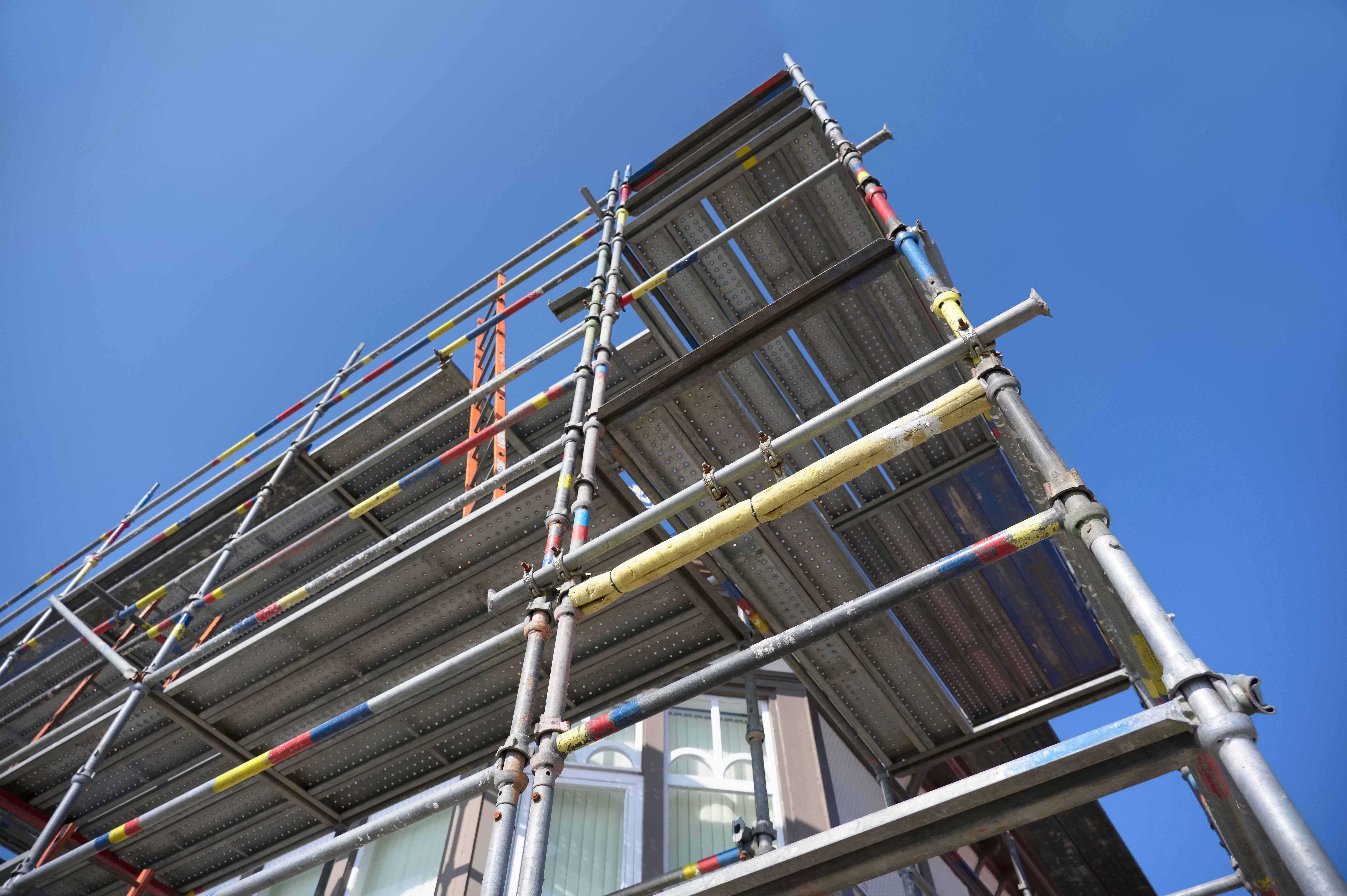 Scaffolding surrounding house development for safe access to construction work