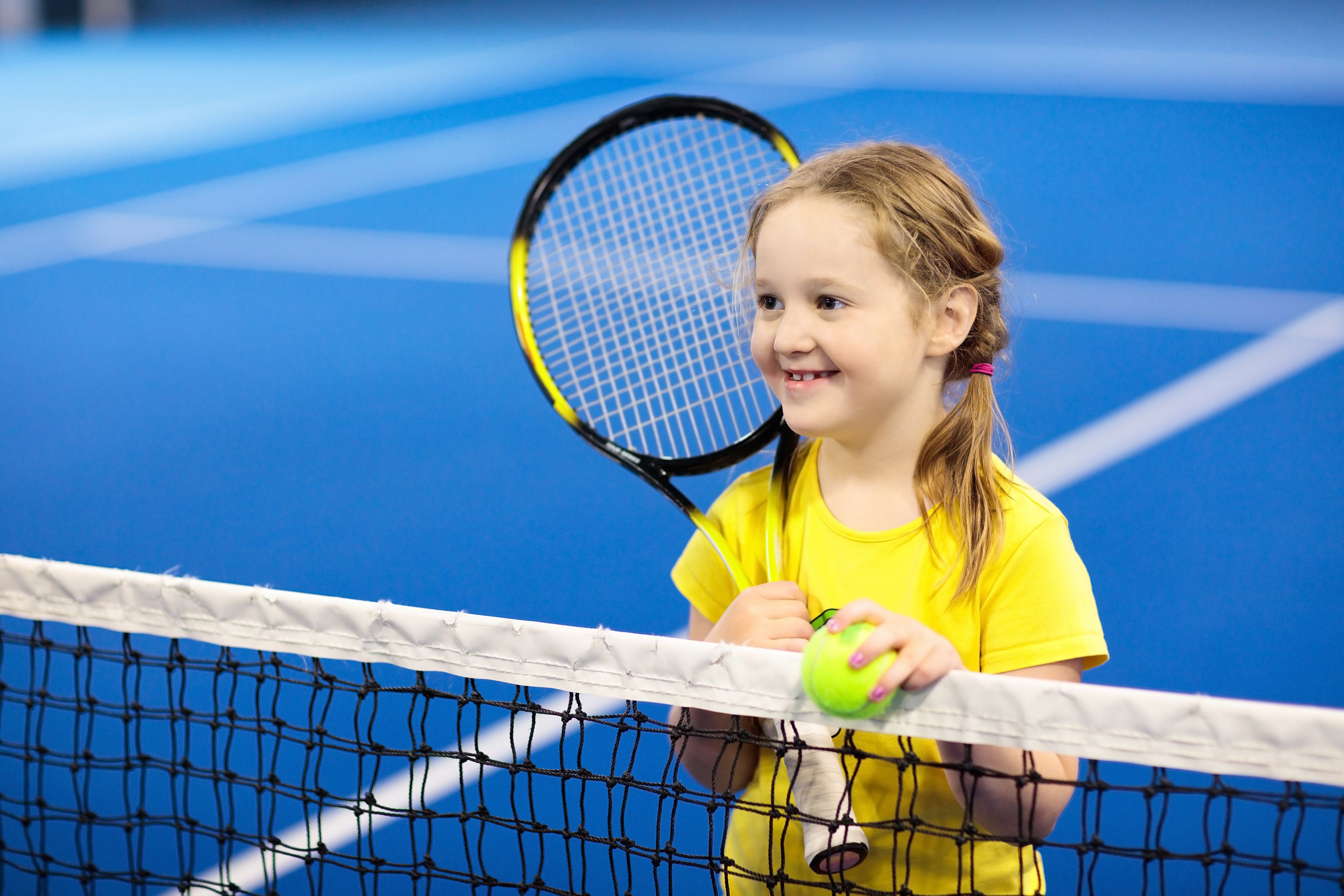 child playing tennis