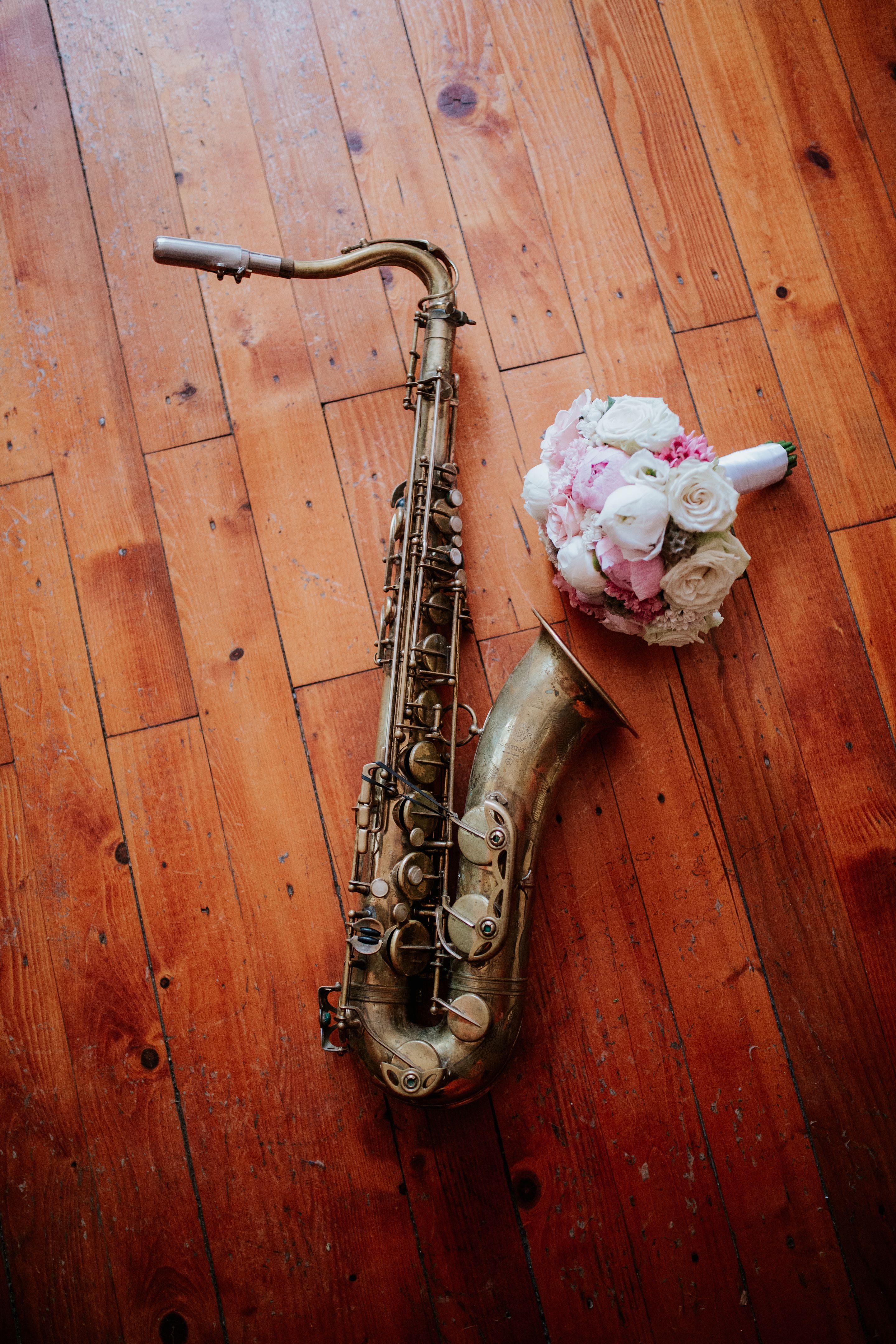 Vintage Saxophone and Bridal Bouquet on Rustic Wooden Floor