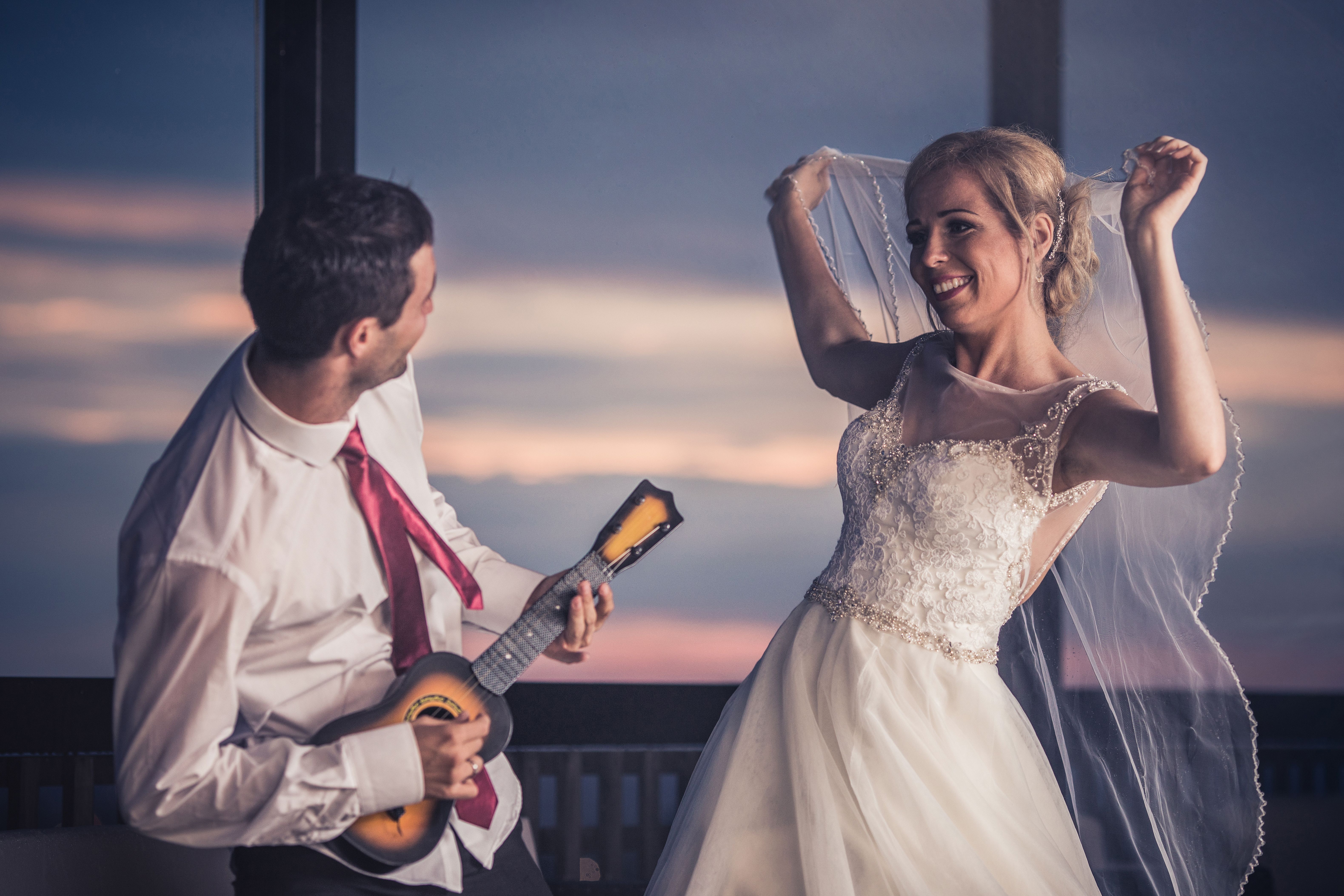 Happy newlywed couple celebrating and having fun on their wedding day.