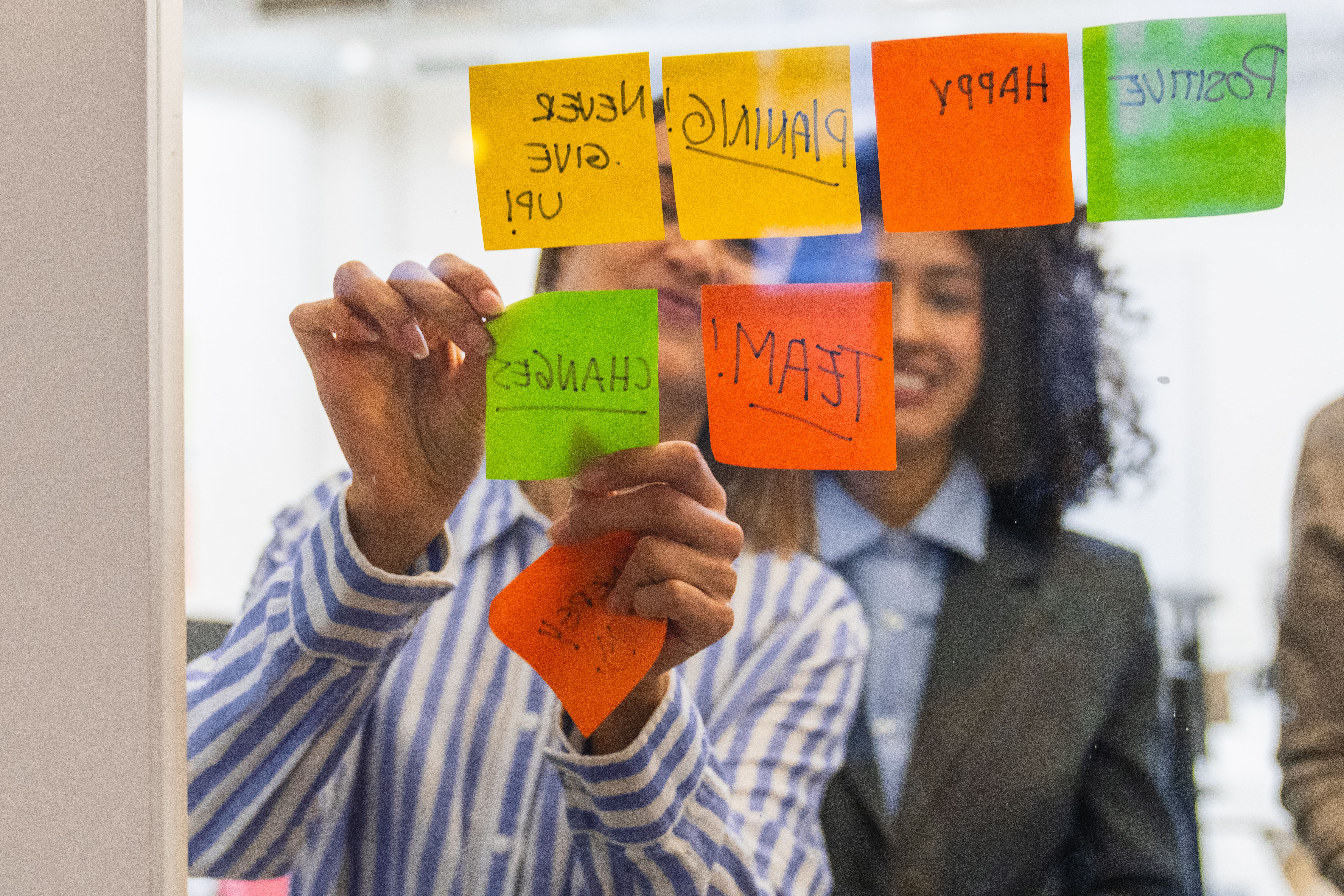 Coworkers planning strategy using sticky notes on glass wall with North Texas fractional COO in Crowley. Coworkers planning strategy using sticky notes on glass wall with North Texas fractional COO in Crowley.