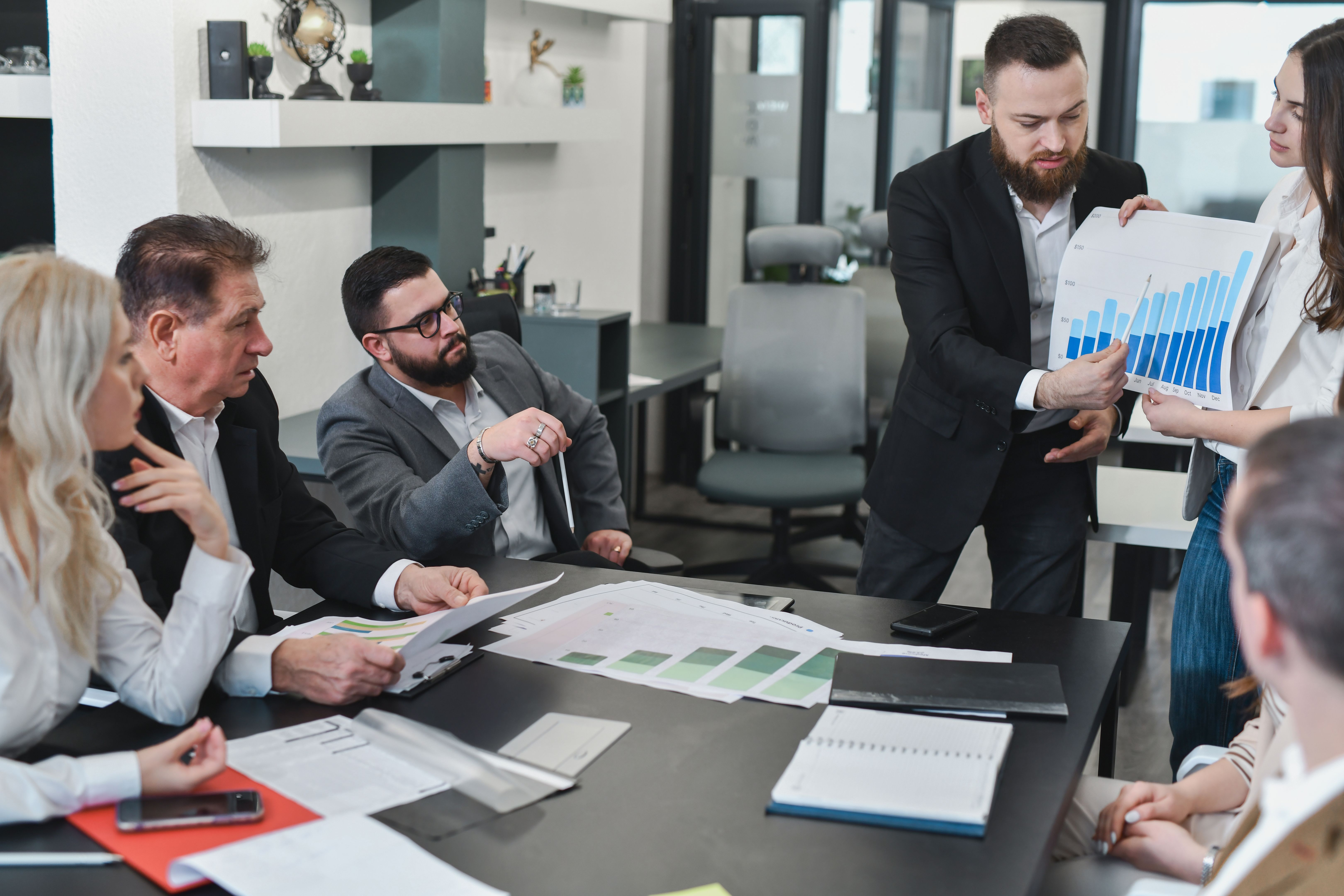 Employees Looking at Manager's Presentation With Curiosity and Focus Employees Looking at Manager's Presentation With Curiosity and Focus