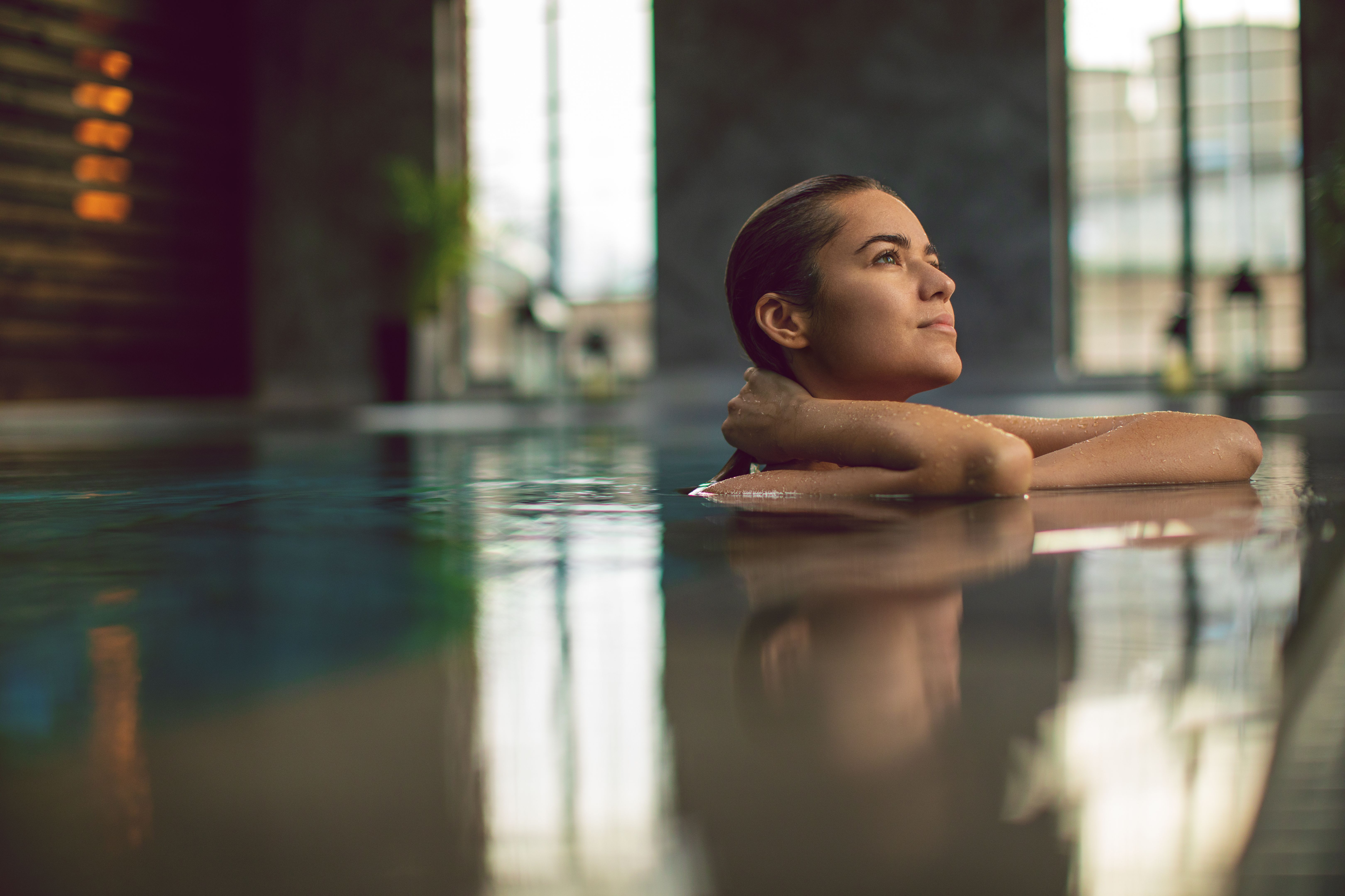 Beautiful young woman relaxing on indoors poolside Beautiful young woman relaxing on indoors poolside