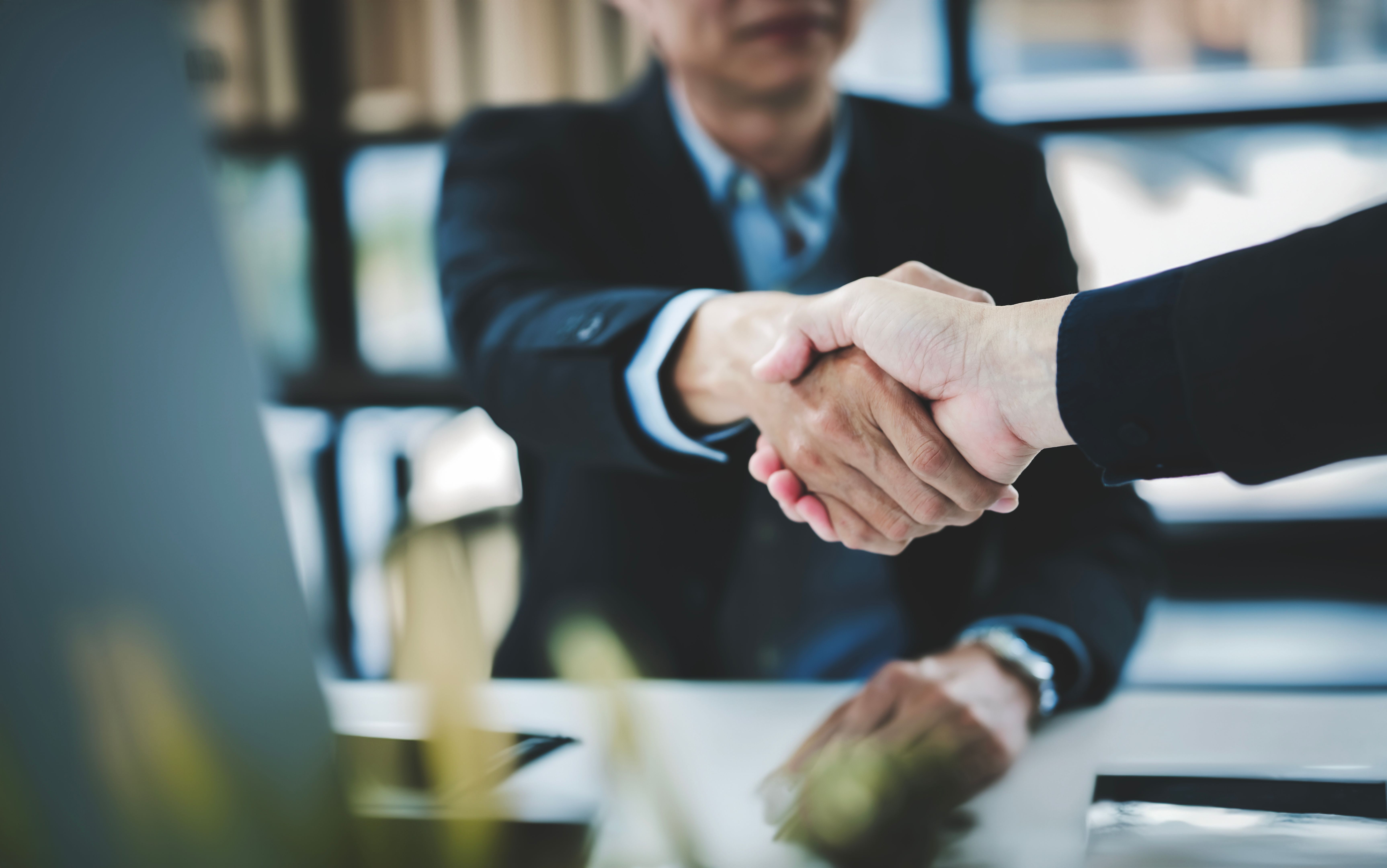 Businessman handshake for teamwork of business merger and acquisition, businessman shake hand with partner