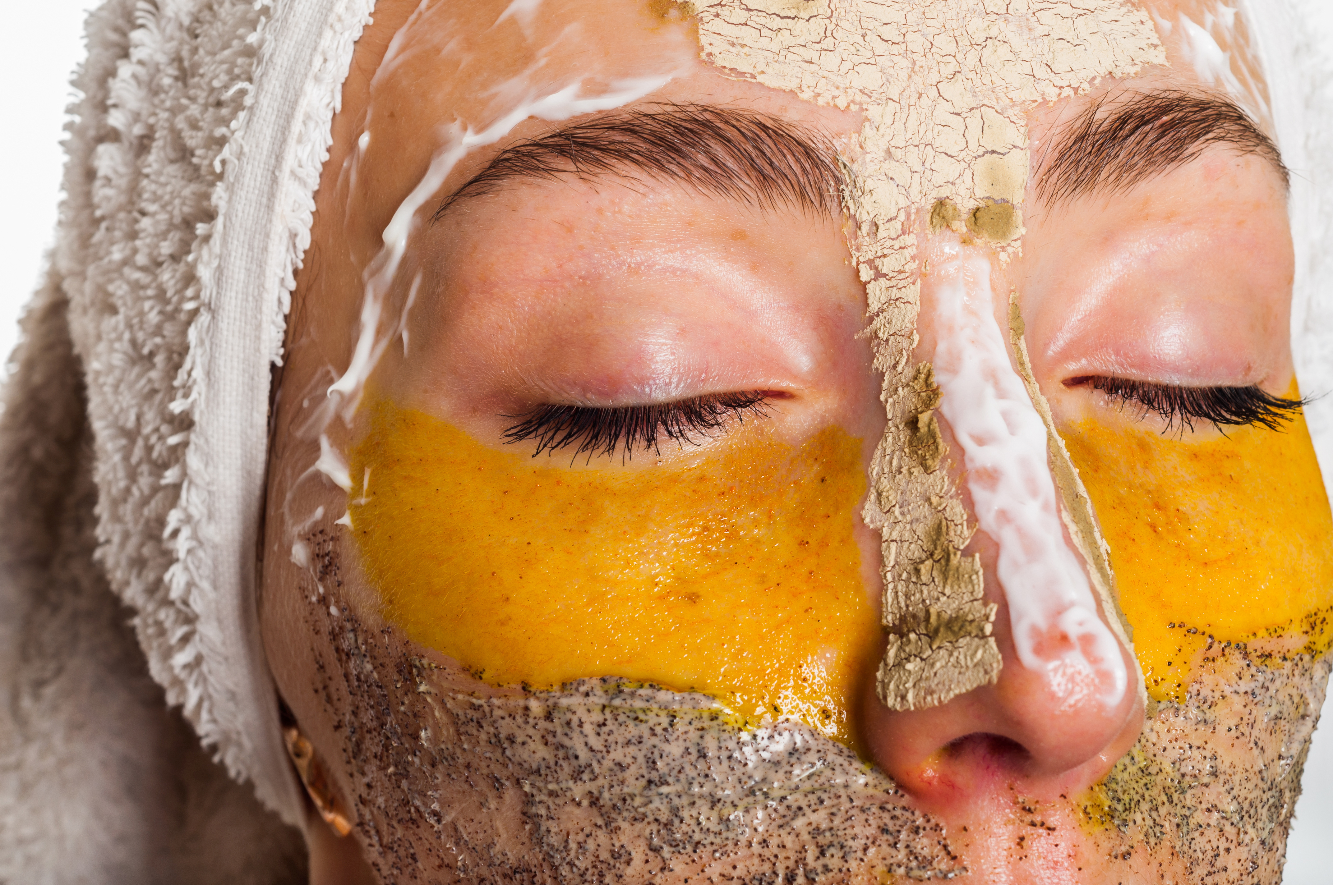 Woman with different masks on her face multi-masking