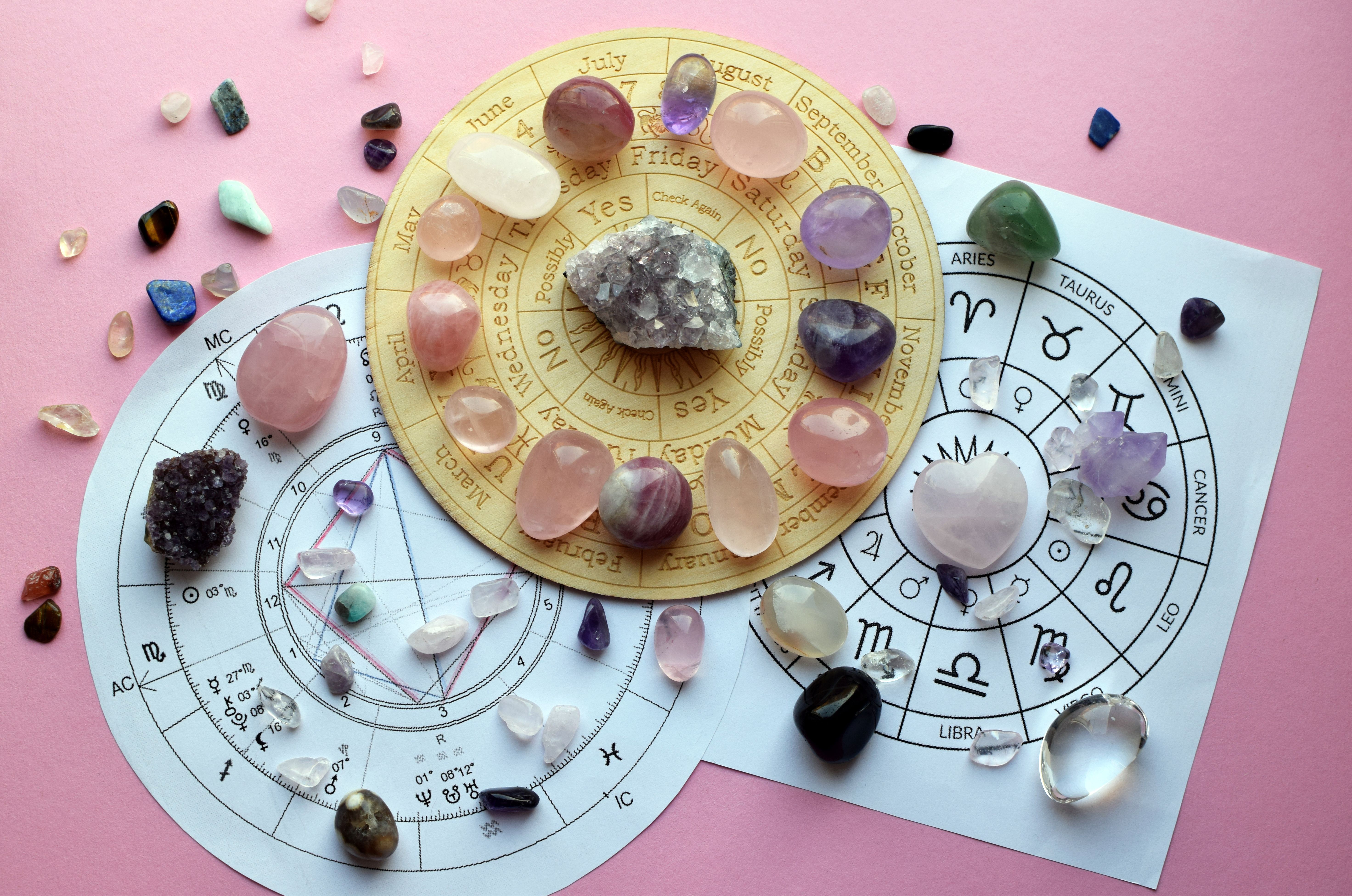 Precious natural stones with a board with symbols of the zodiac signs. Natal charts for predictions. Predictions, witchcraft, spiritual esoteric practice.