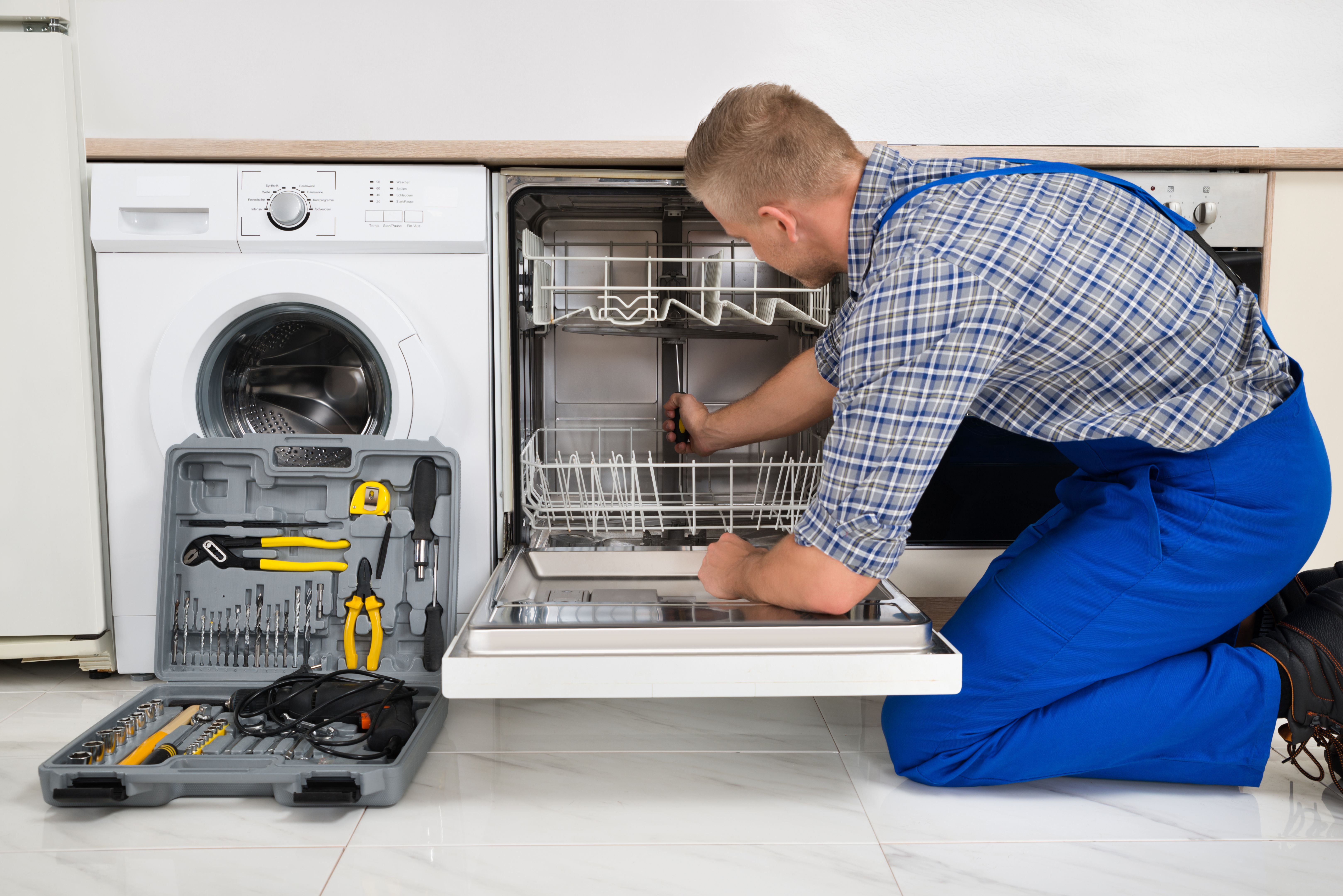 technician repairing dishwasher