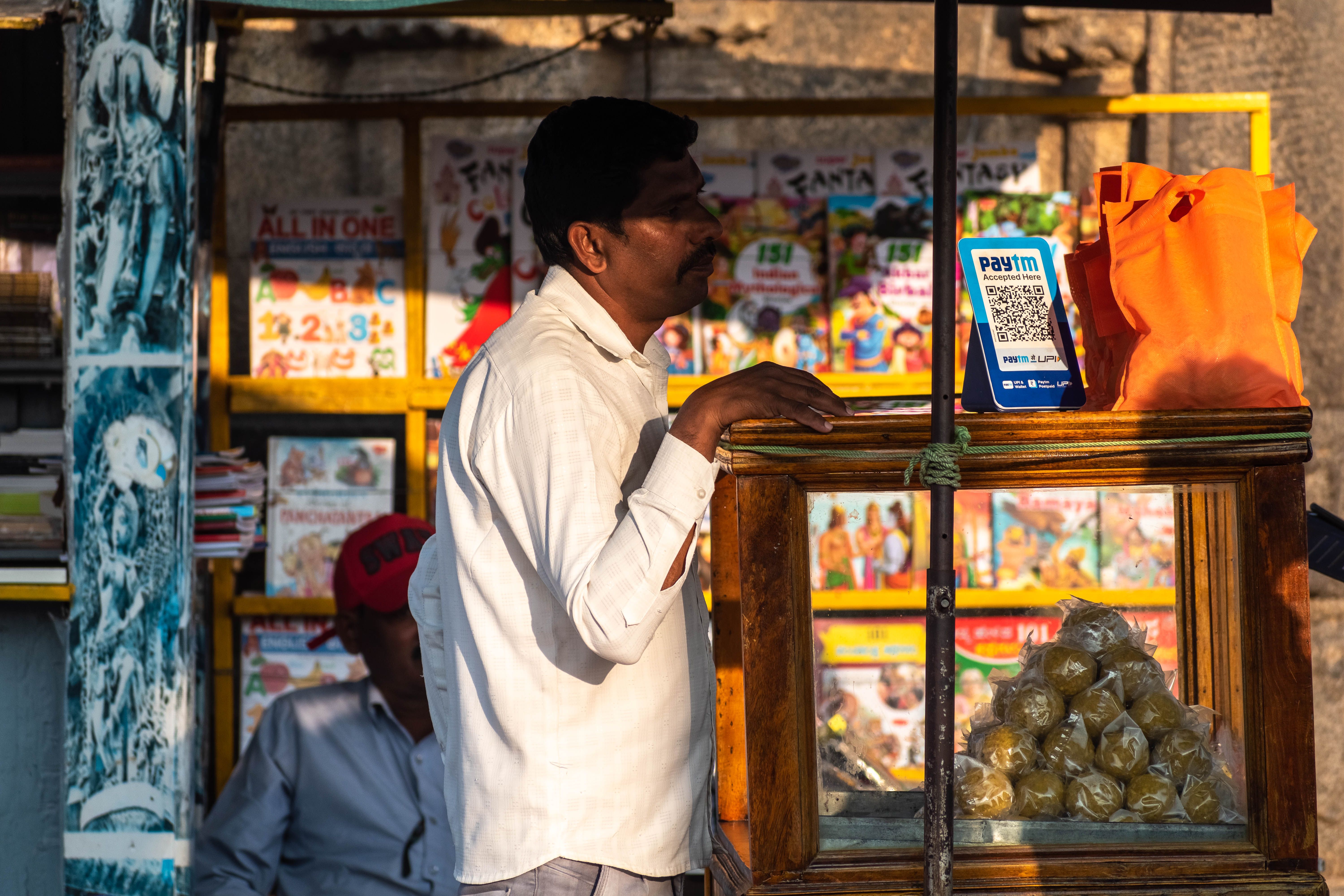 An Indian street vendor with a paytm upi QR cod An Indian street vendor with a paytm upi QR cod