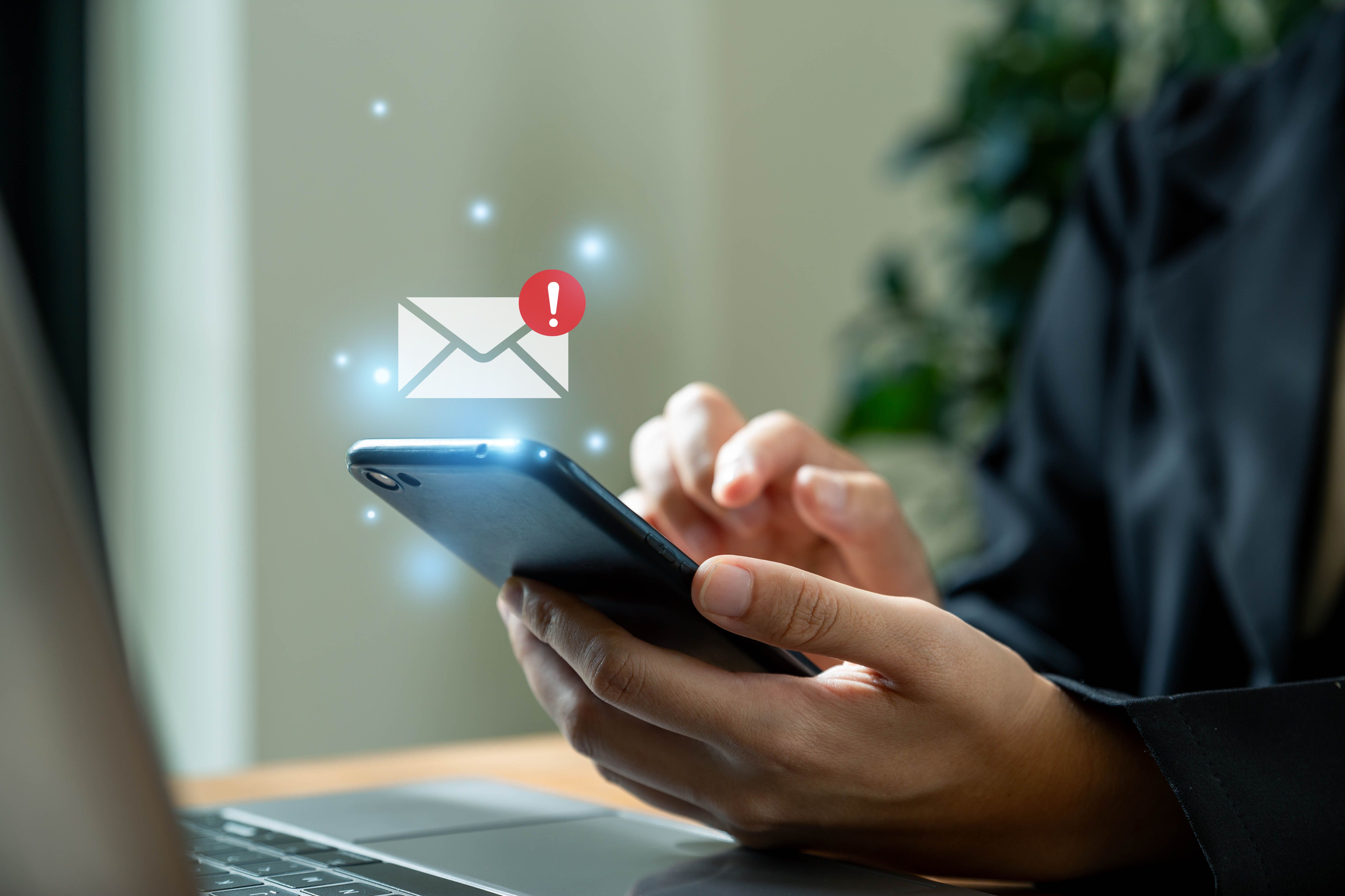 Businesswoman using phone with email danger alert. Businesswoman using phone with email danger alert.