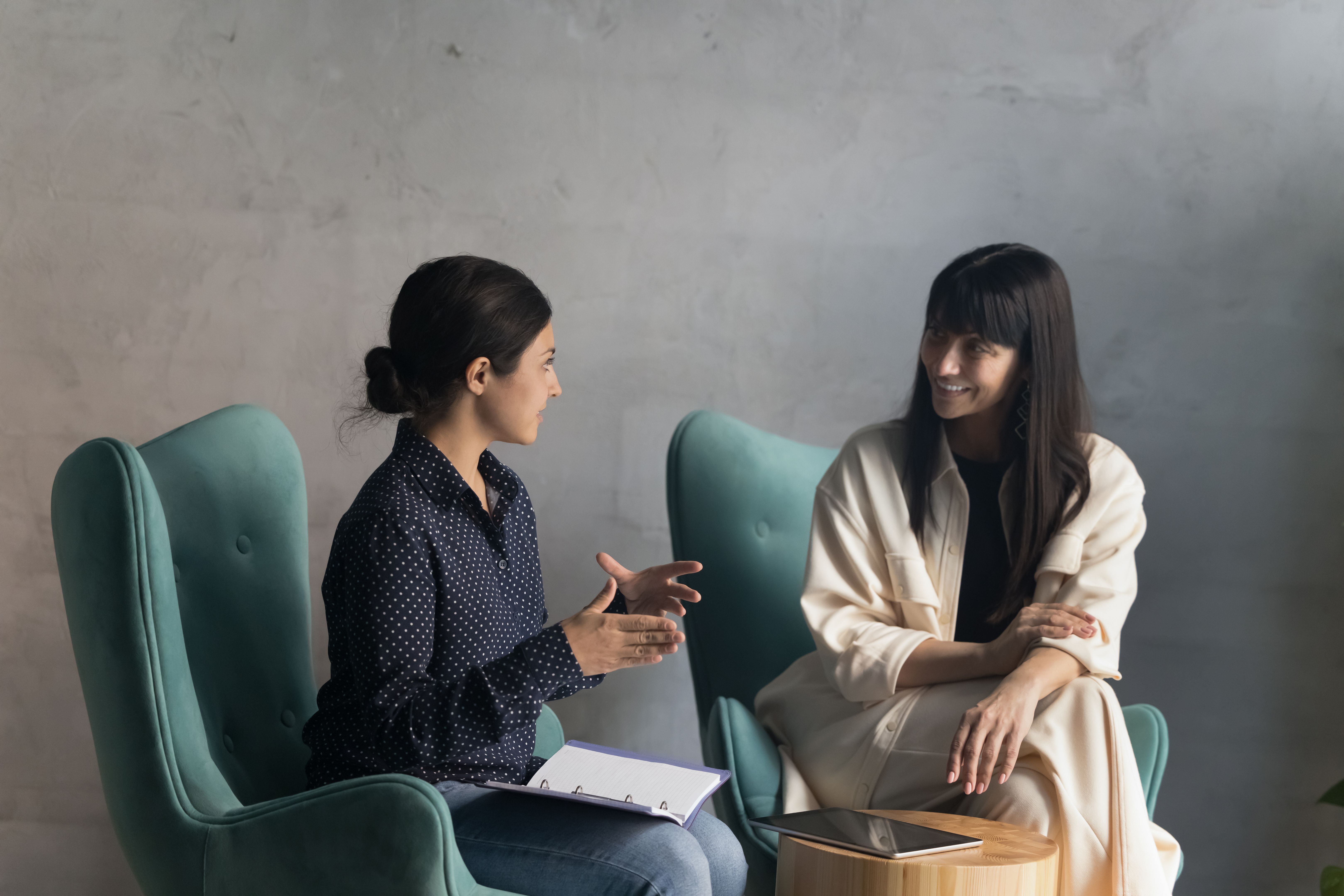 Negotiations of two multi ethnic businesswomen in modern office